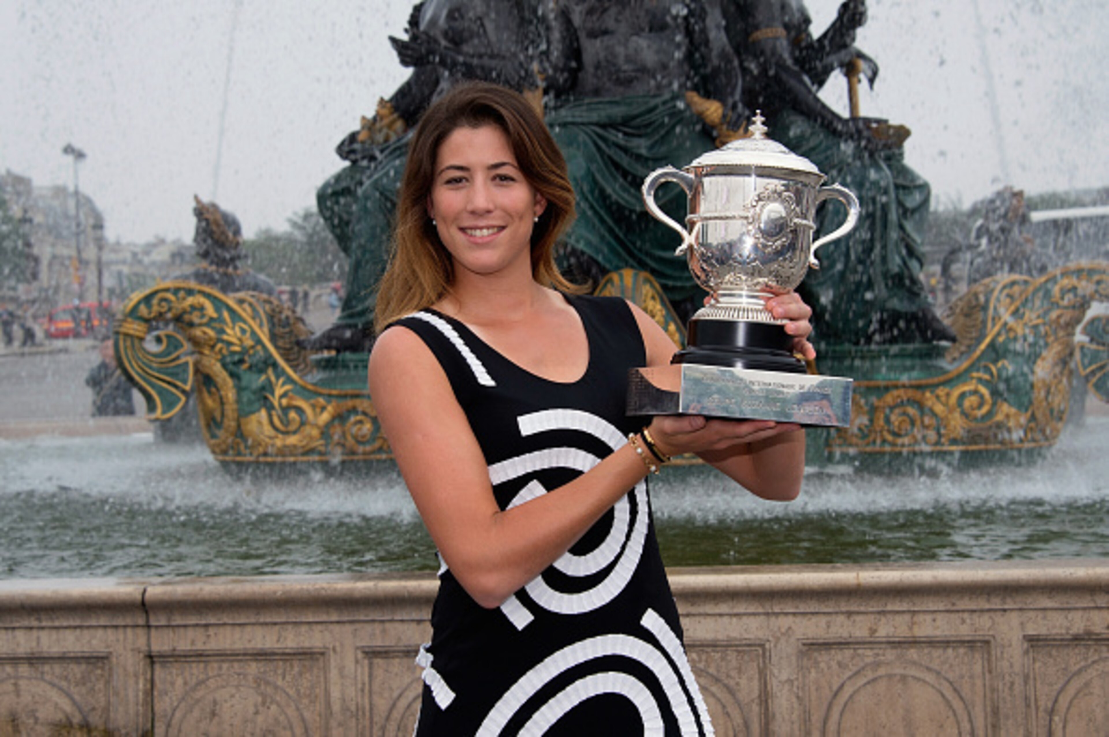 French Open champion Muguruza holds her trophy in Paris.