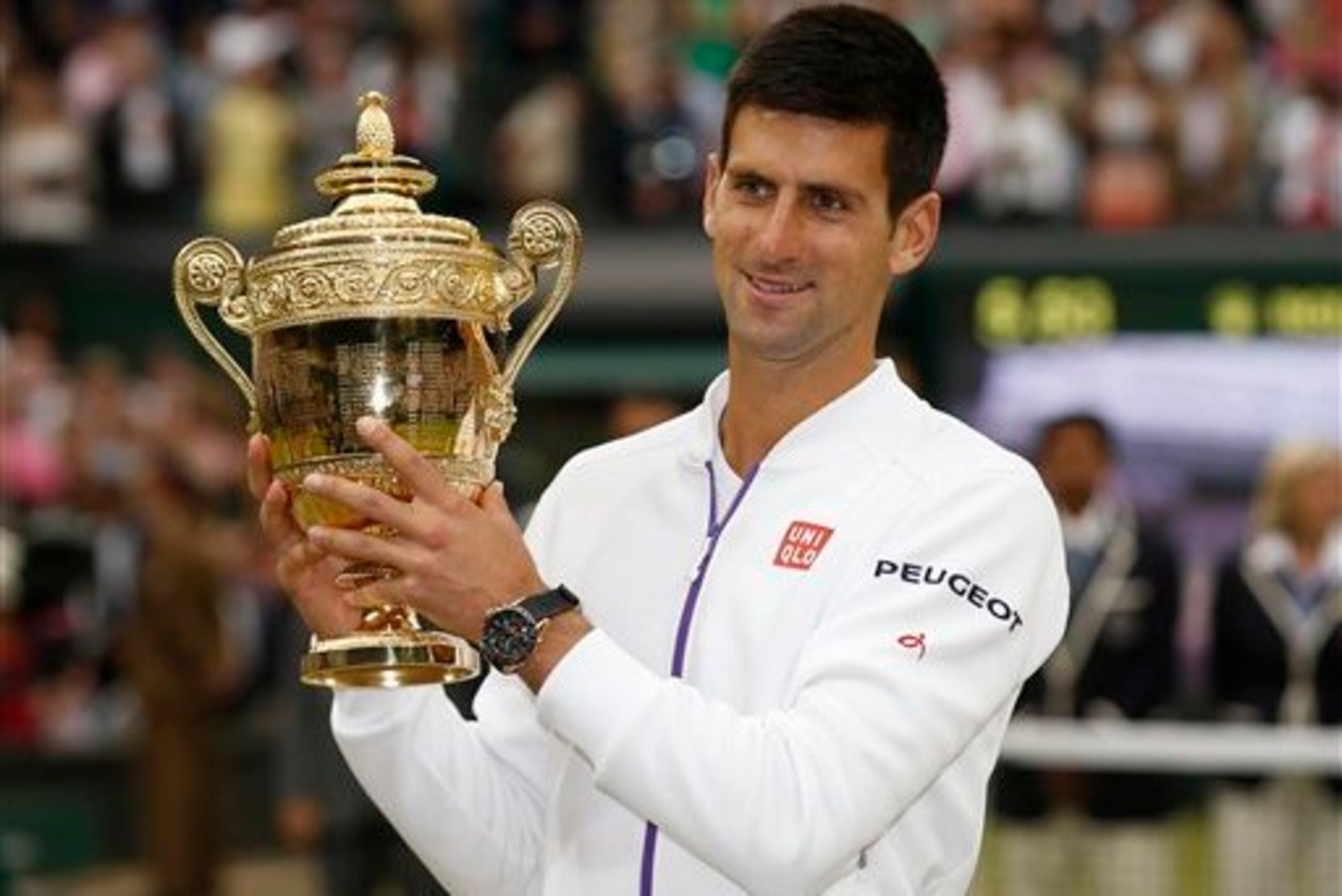 Novak Djokovic shows off his trophy after winning Wimbledon 2015. Novak Djokovic shows off his trophy after winning Wimbledon 2015.