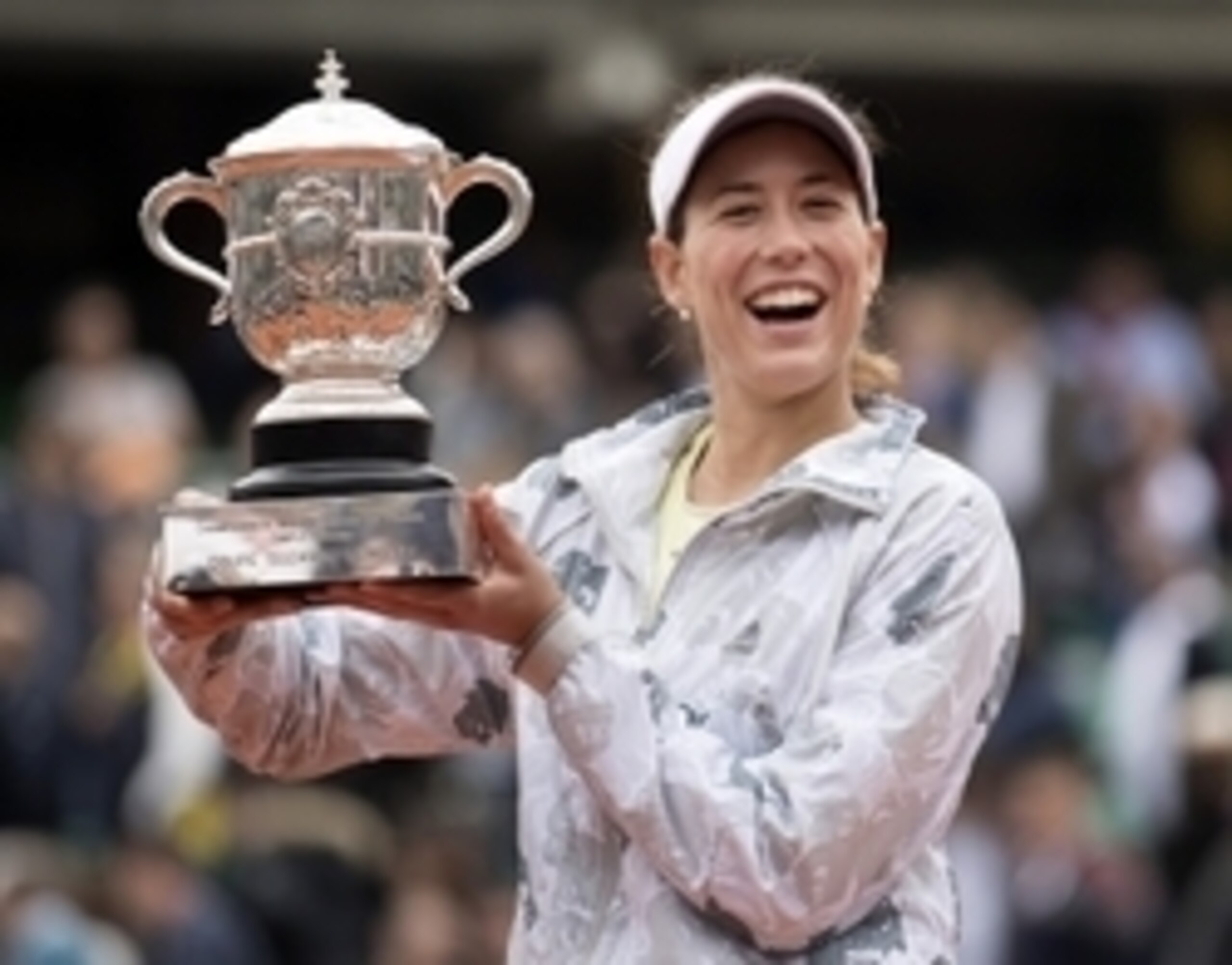 Garbine Muguruza smiles with her trophy after winning the 2016 French Open.