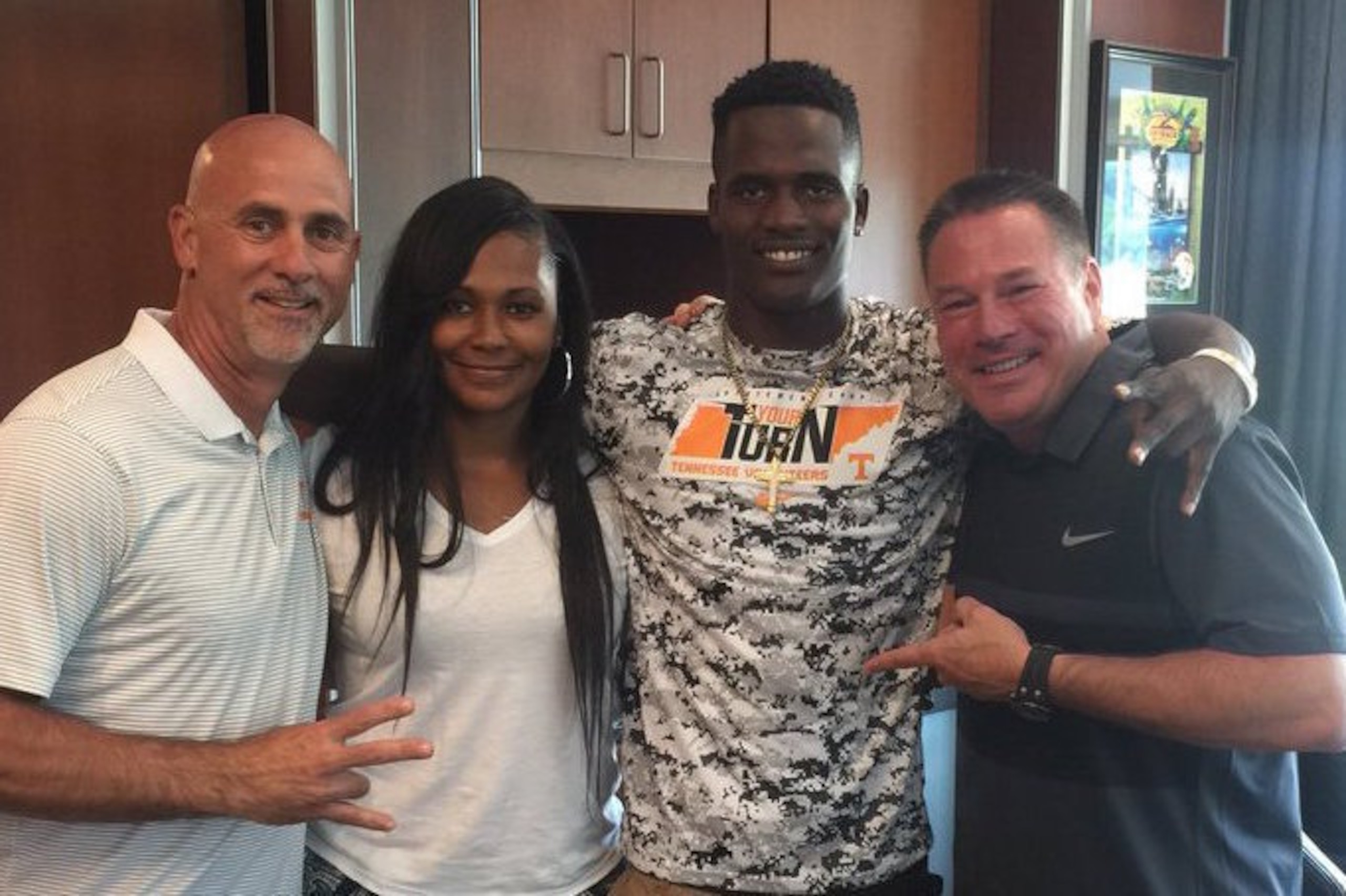 Maleik Gray (third from left) along with Tennessee defensive backs coach Willie Martinez, Gray's mother and UT head coach Butch Jones