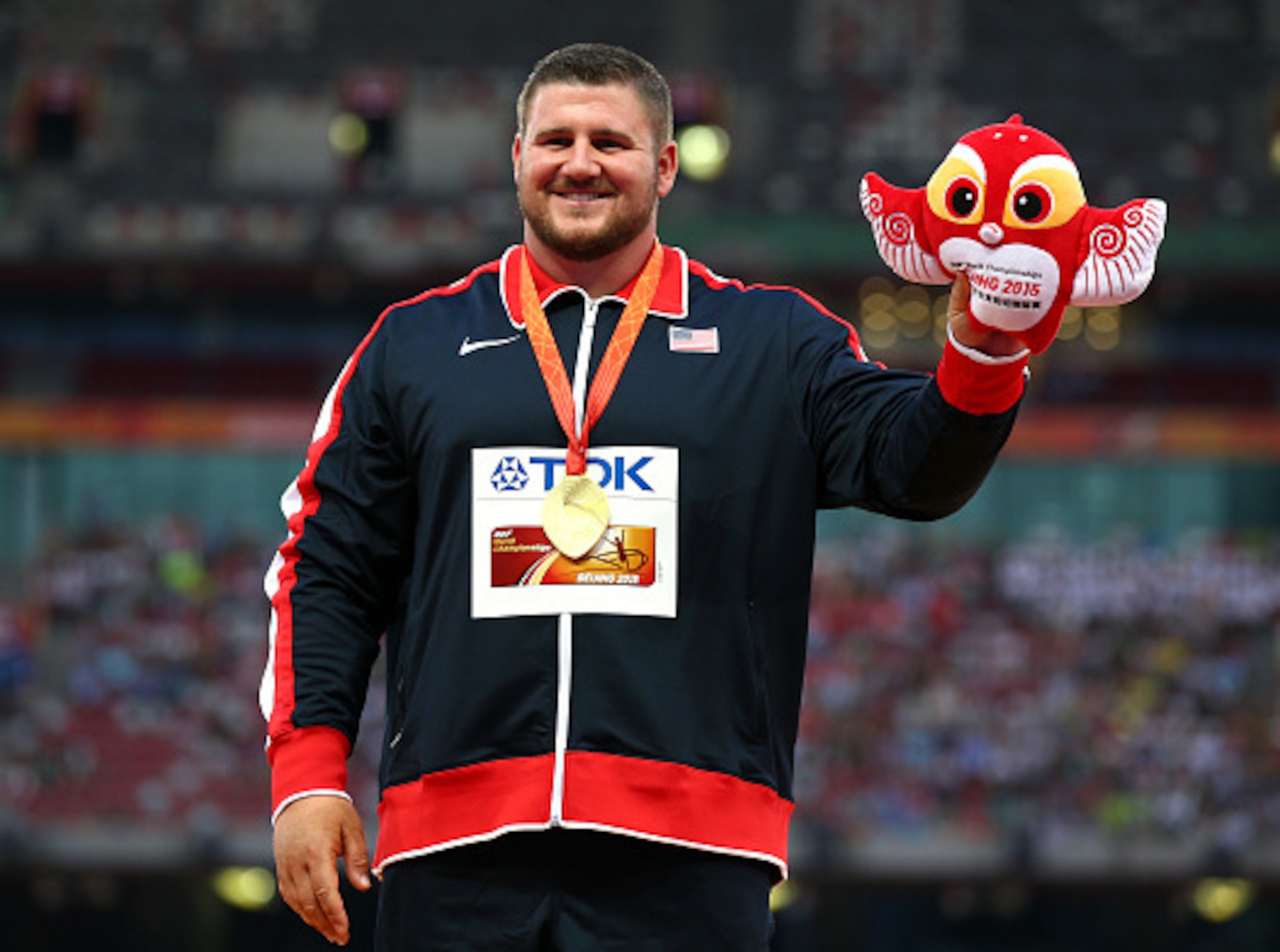 Joe Kovacs with the 2015 World Championship gold and some sort of...owl?