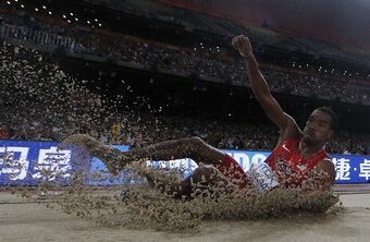 Christian Taylor hits the sand in Beijing after another duel with gravity.