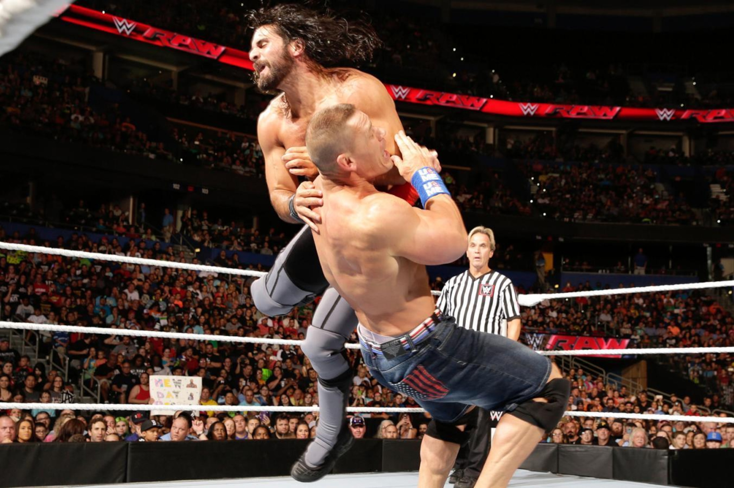 Seth Rollins and John Cena battling on Raw.
