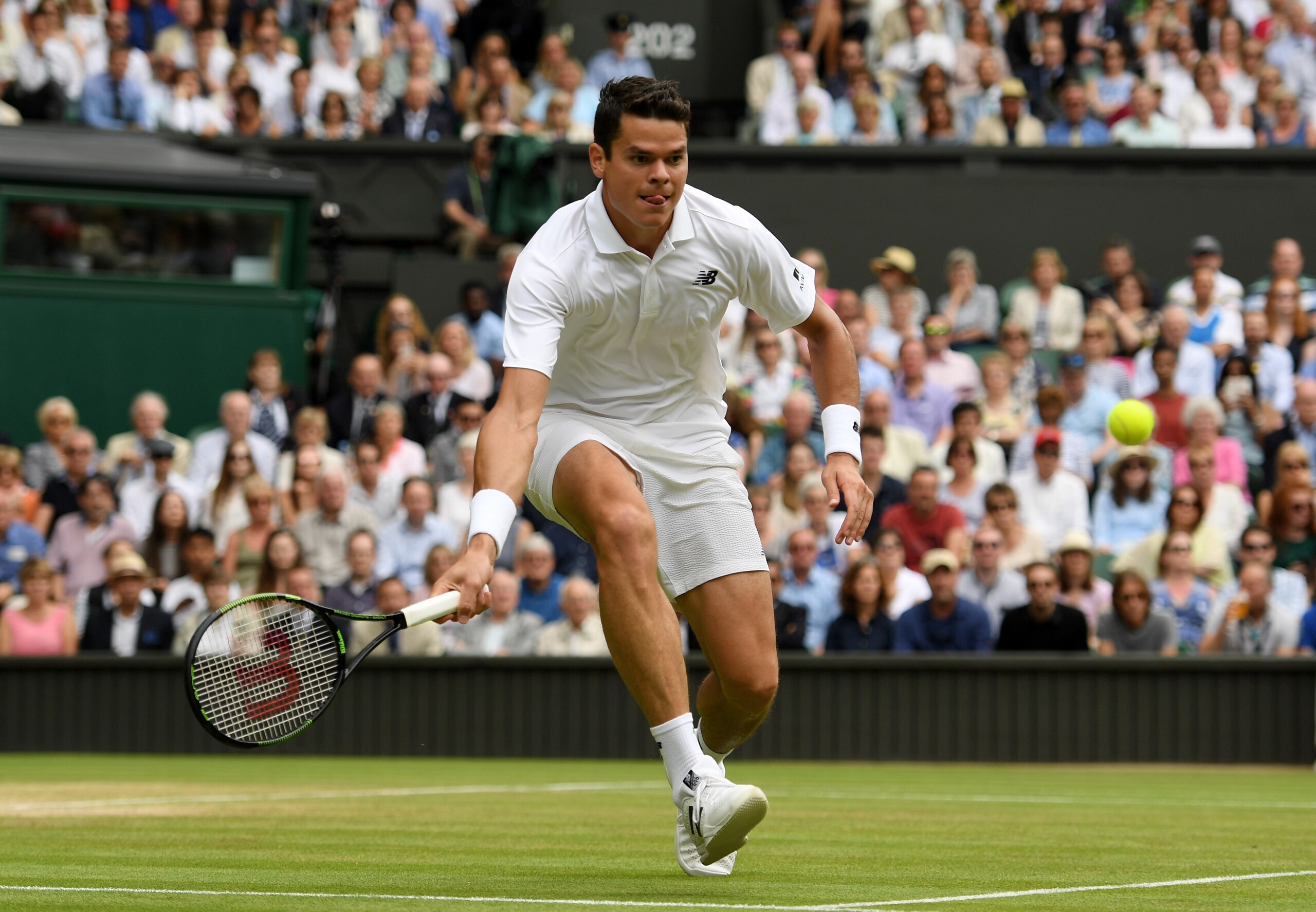 Milos Raonic closes in on a volley during a match at Wimbledon 2016.