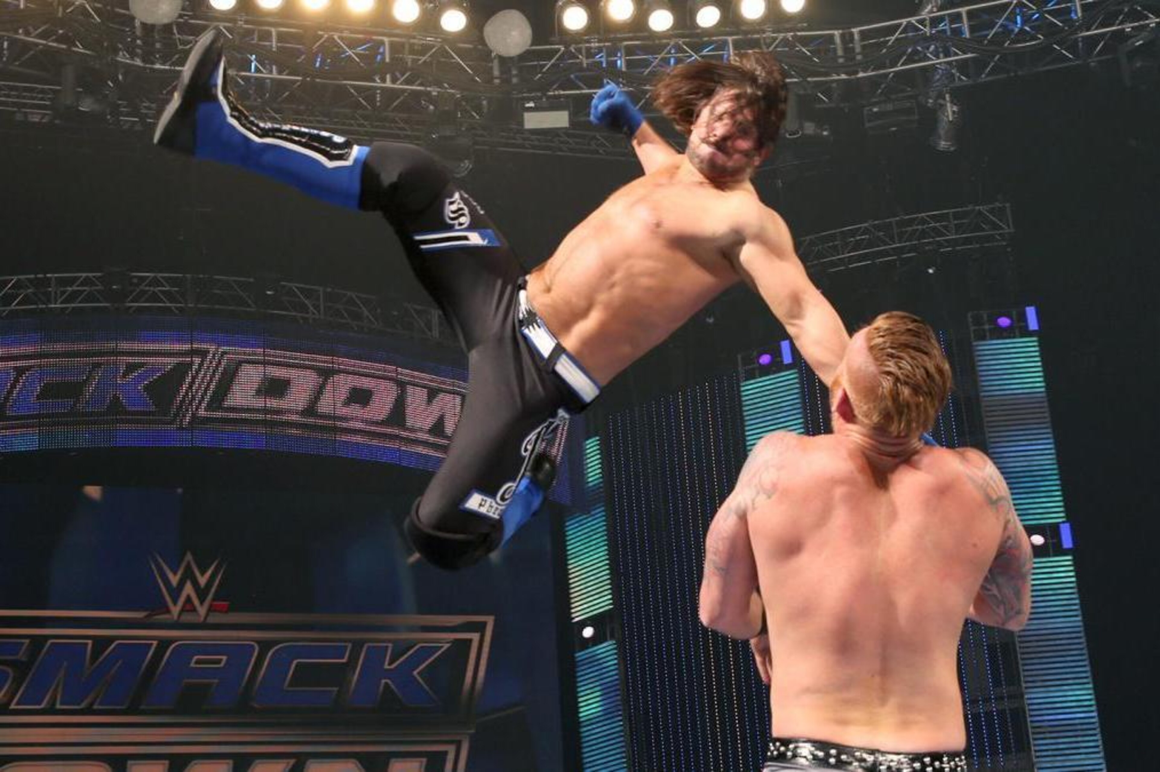 AJ Styles hitting Heath Slater with the Phenomenal Forearm.