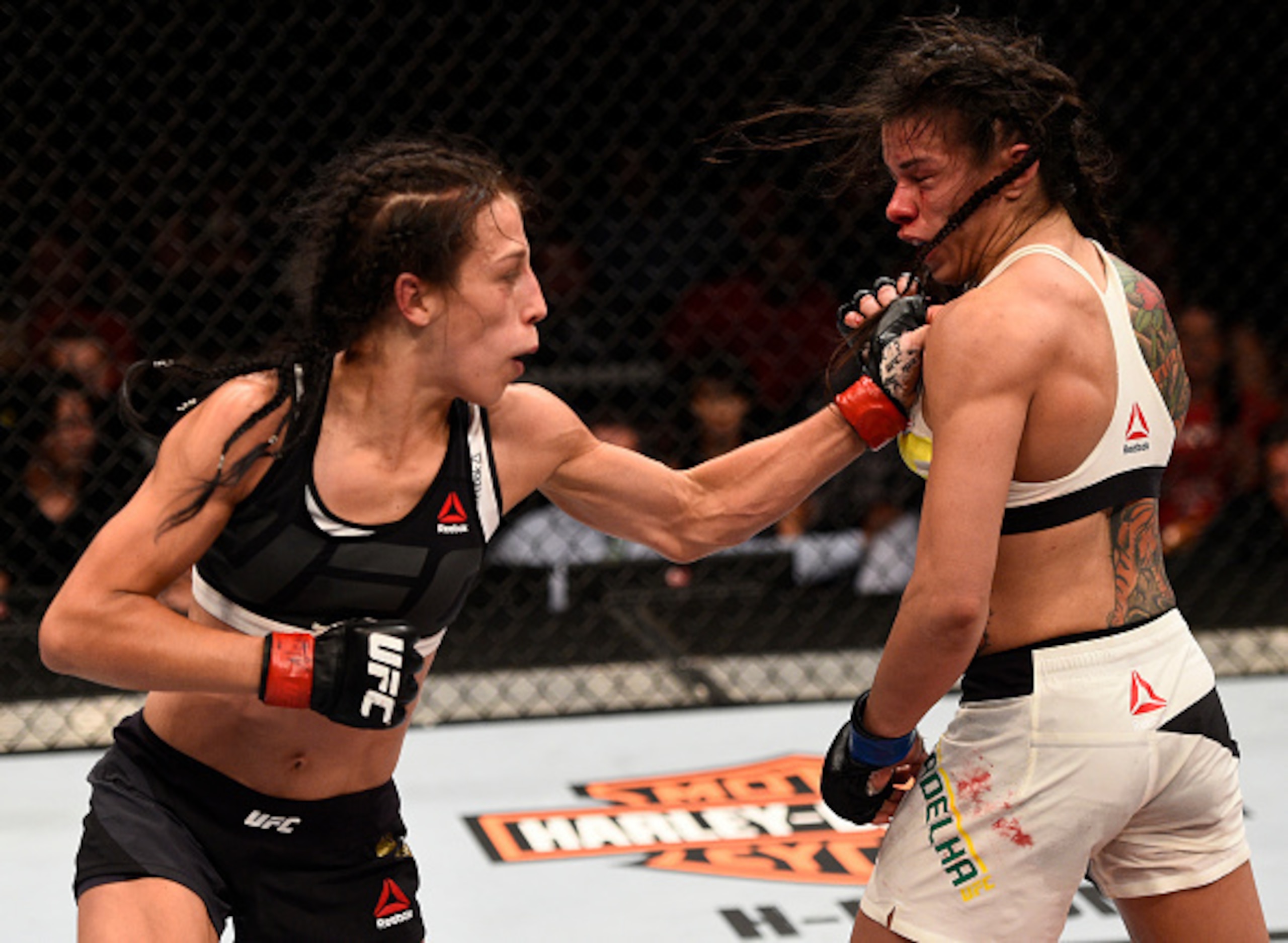Jedrzejczyk (left) punches Gadelha.