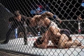 Kevin Lee (top) hammers Jake Matthews