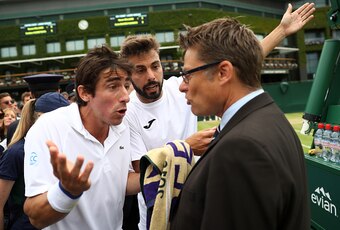 Pablo Cuevas (left) and Marcel Granollers argue with a Wimbledon official over bathroom break rules.