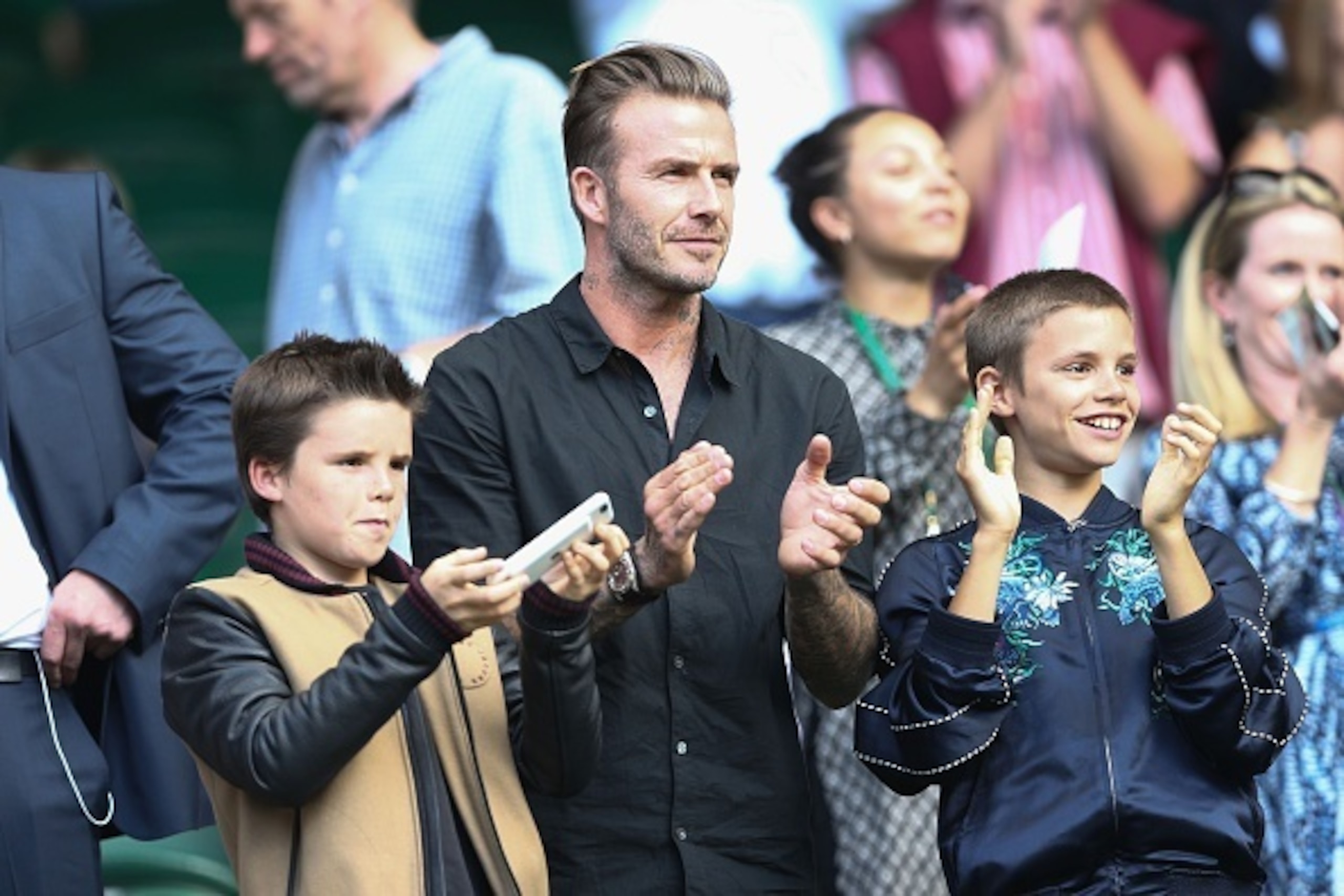 David Beckham with sons Romeo and Cruz during a match at Wimbledon 2016. David Beckham with sons Romeo and Cruz during a match at Wimbledon 2016.