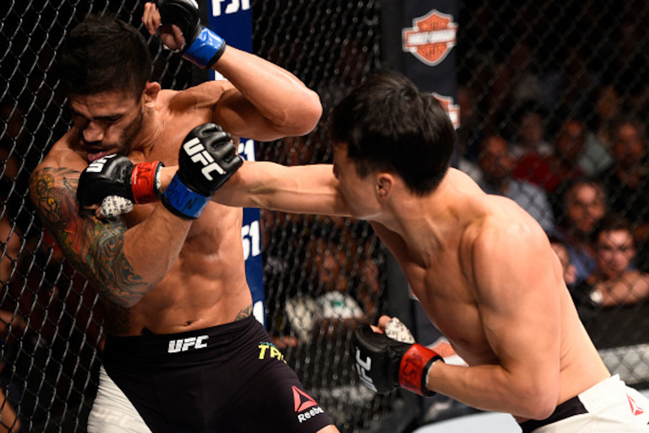 Doo Ho Choi (right) hits Thiago Tavares.