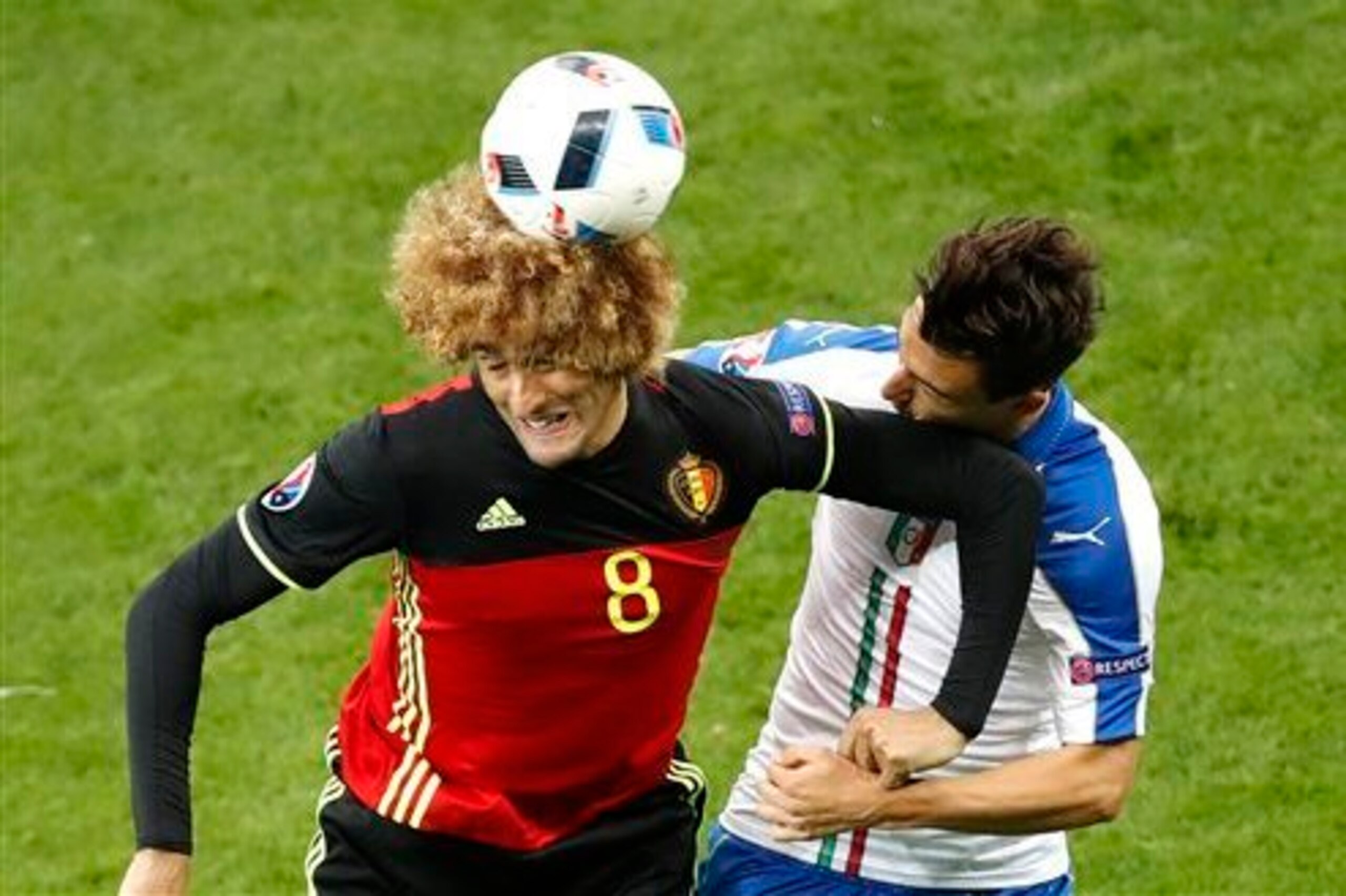 Marouane Fellaini elbows club teammate Matteo Darmian in the face during Belgium and Italy's group stage meeting. Marouane Fellaini elbows club teammate Matteo Darmian in the face during Belgium and Italy's group stage meeting.