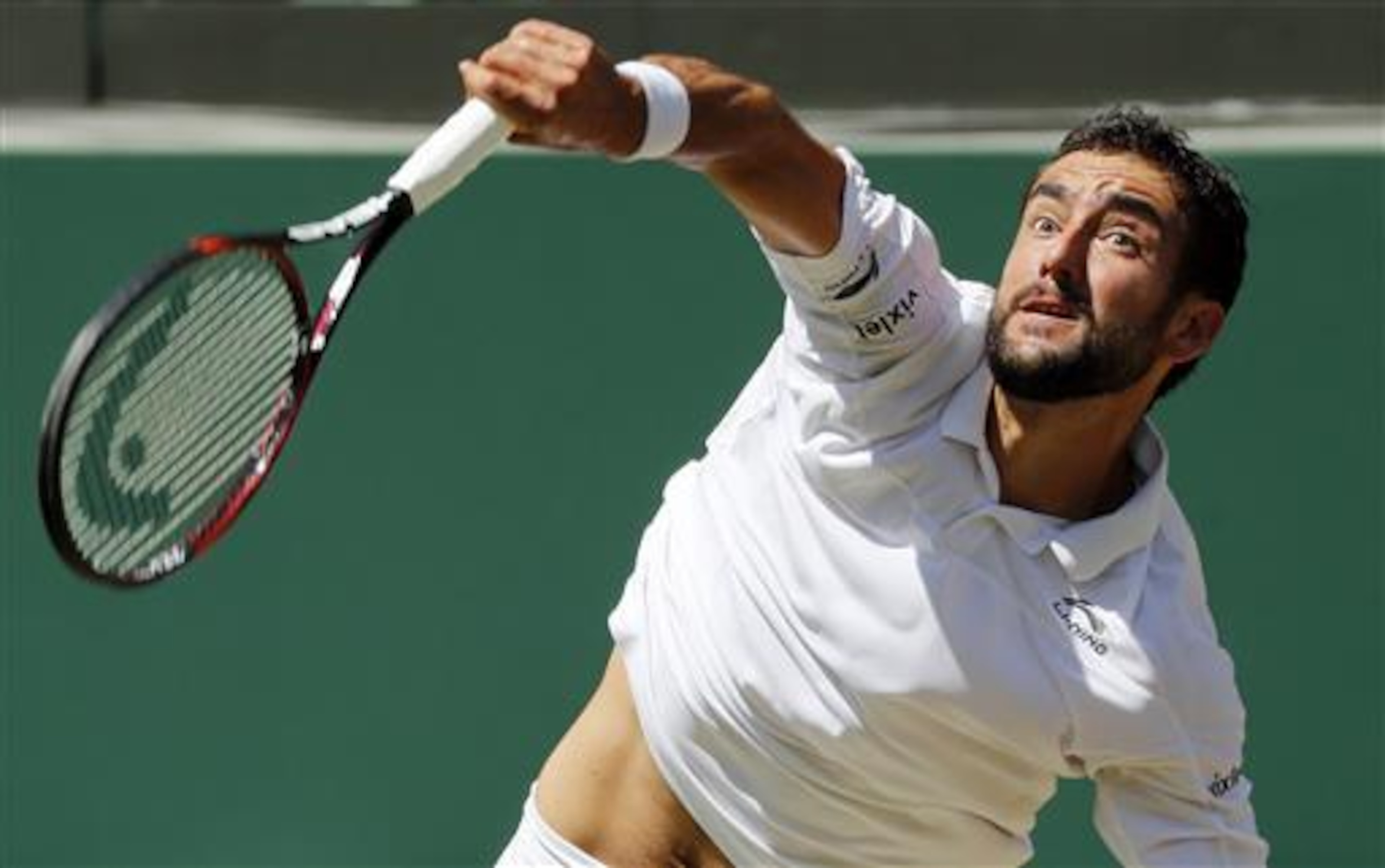 Marin Cilic serves during 2016 Wimbledon quarterfinals.