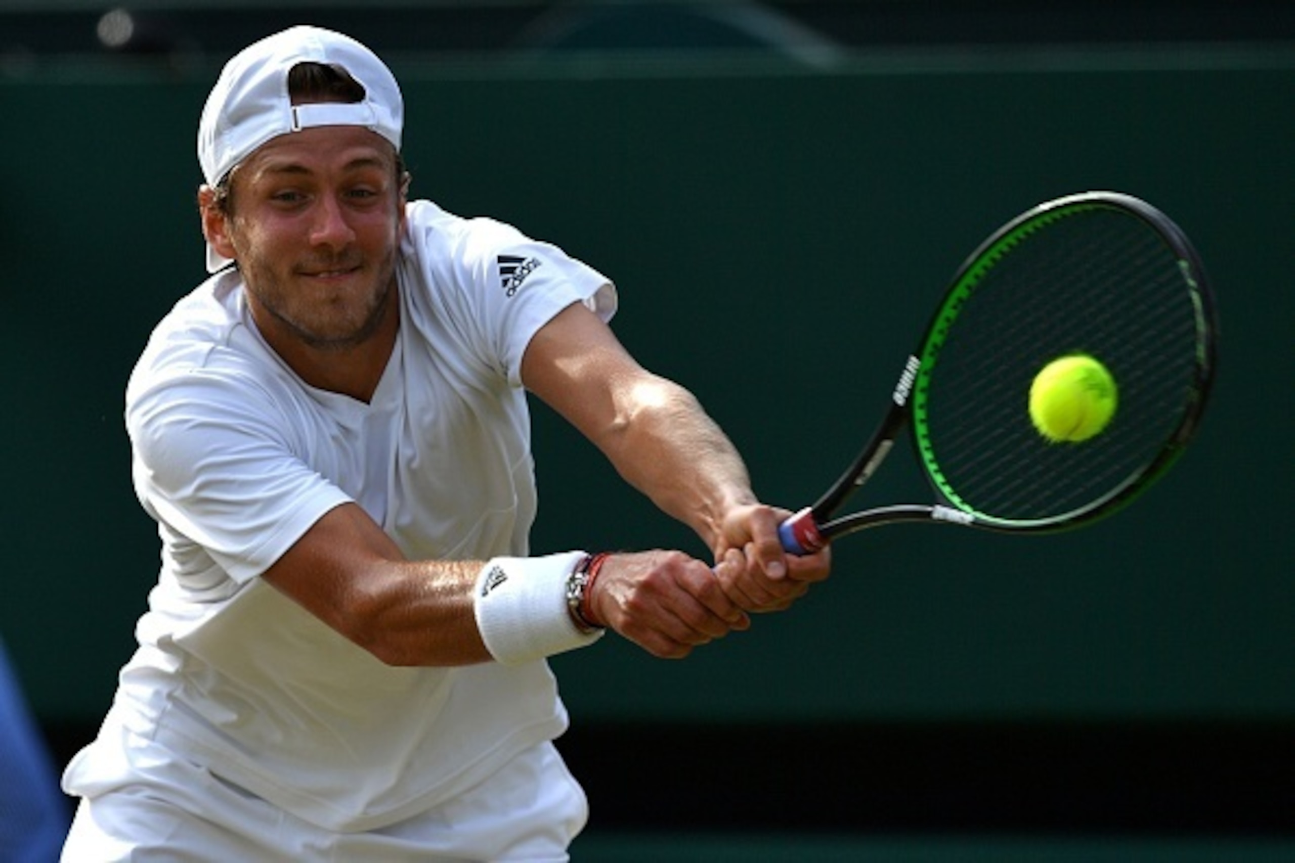 Lucas Pouille hits a backhand during a match at Wimbledon 2016.