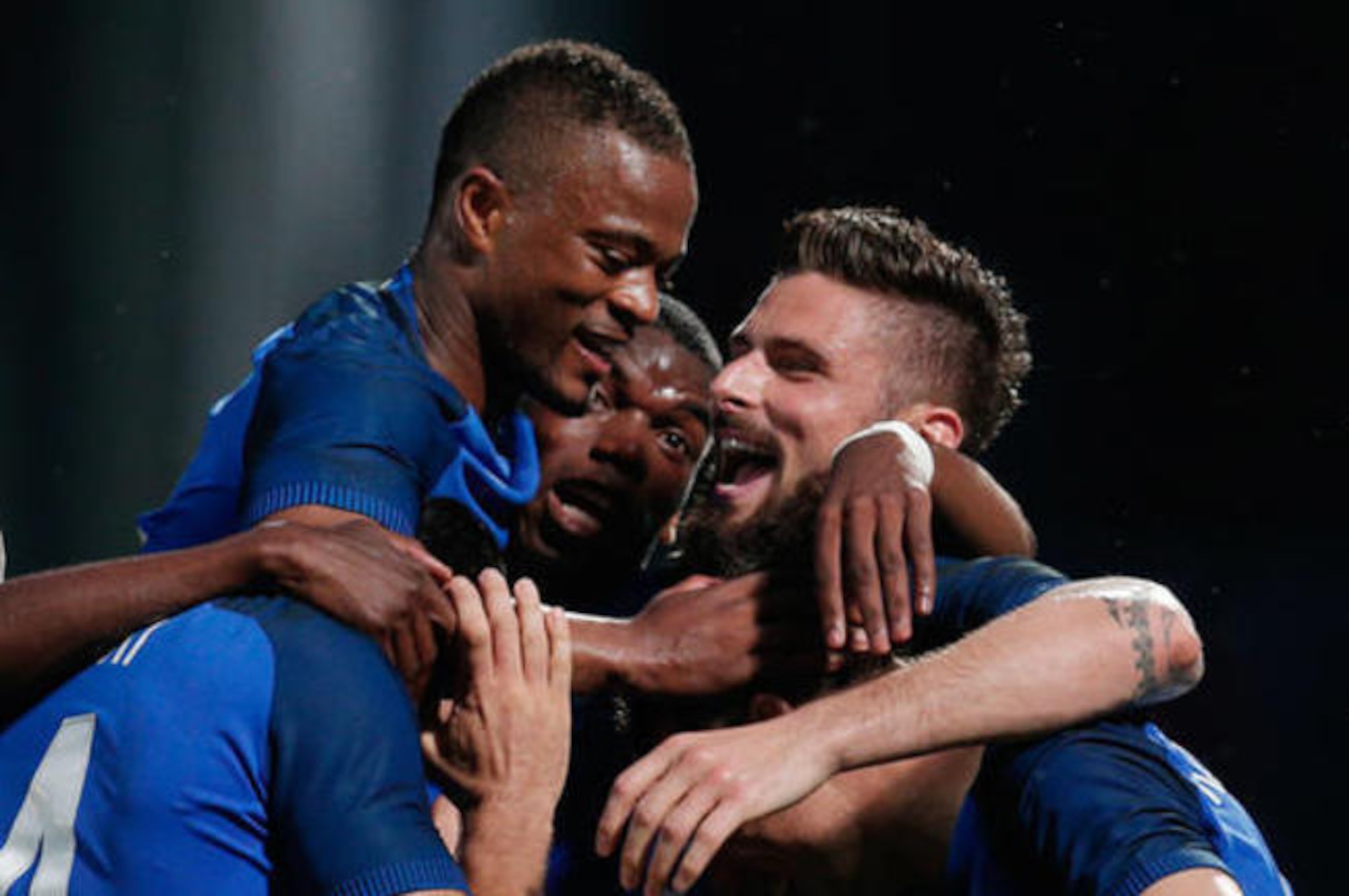 Patrice Evra celebrates with his France team-mates.