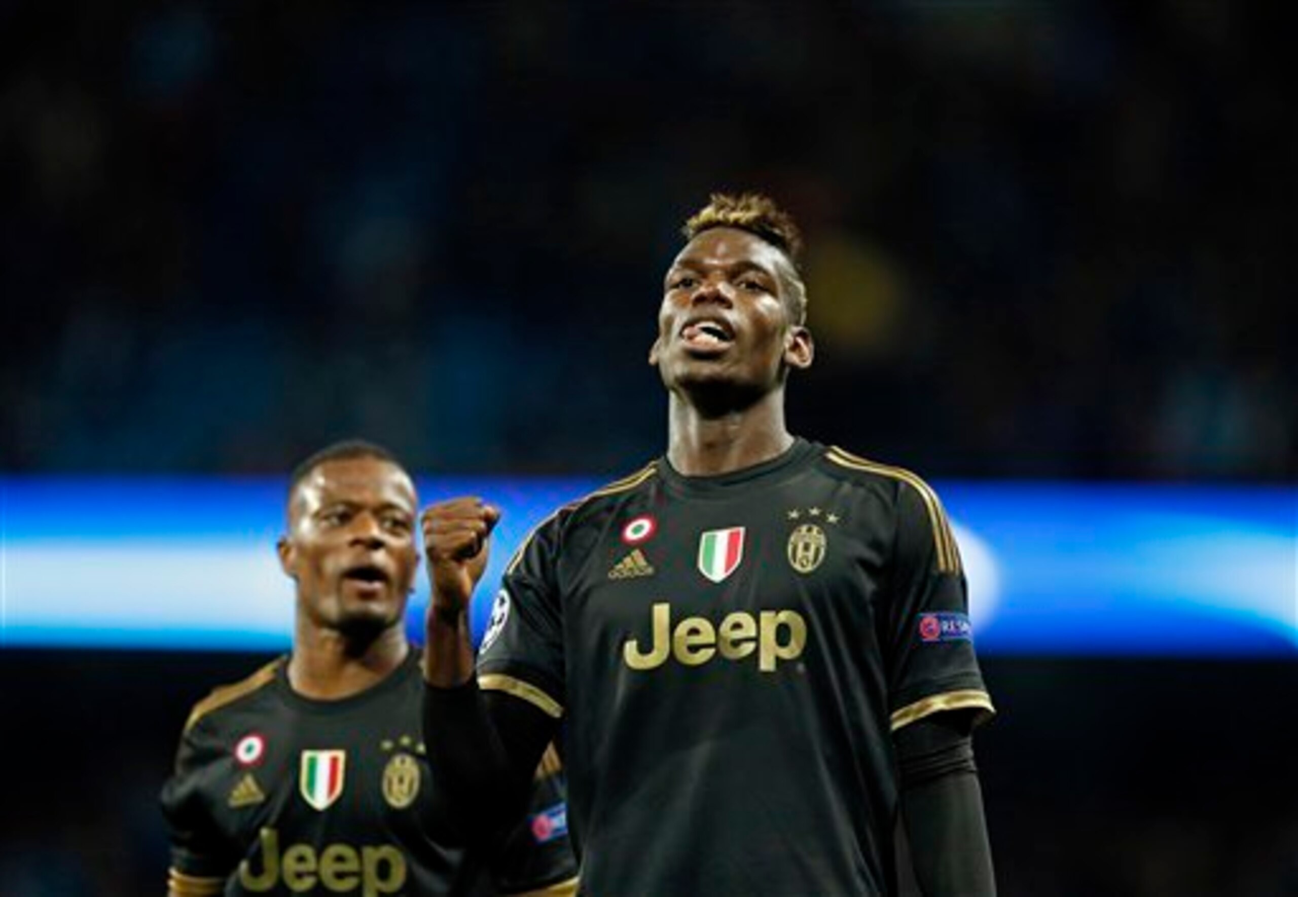 Pogba celebrates a goal for Juventus, flanked by Evra.