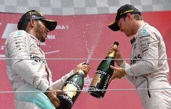 Lewis Hamilton and Nico Rosberg celebrate on the British Grand Prix podium.