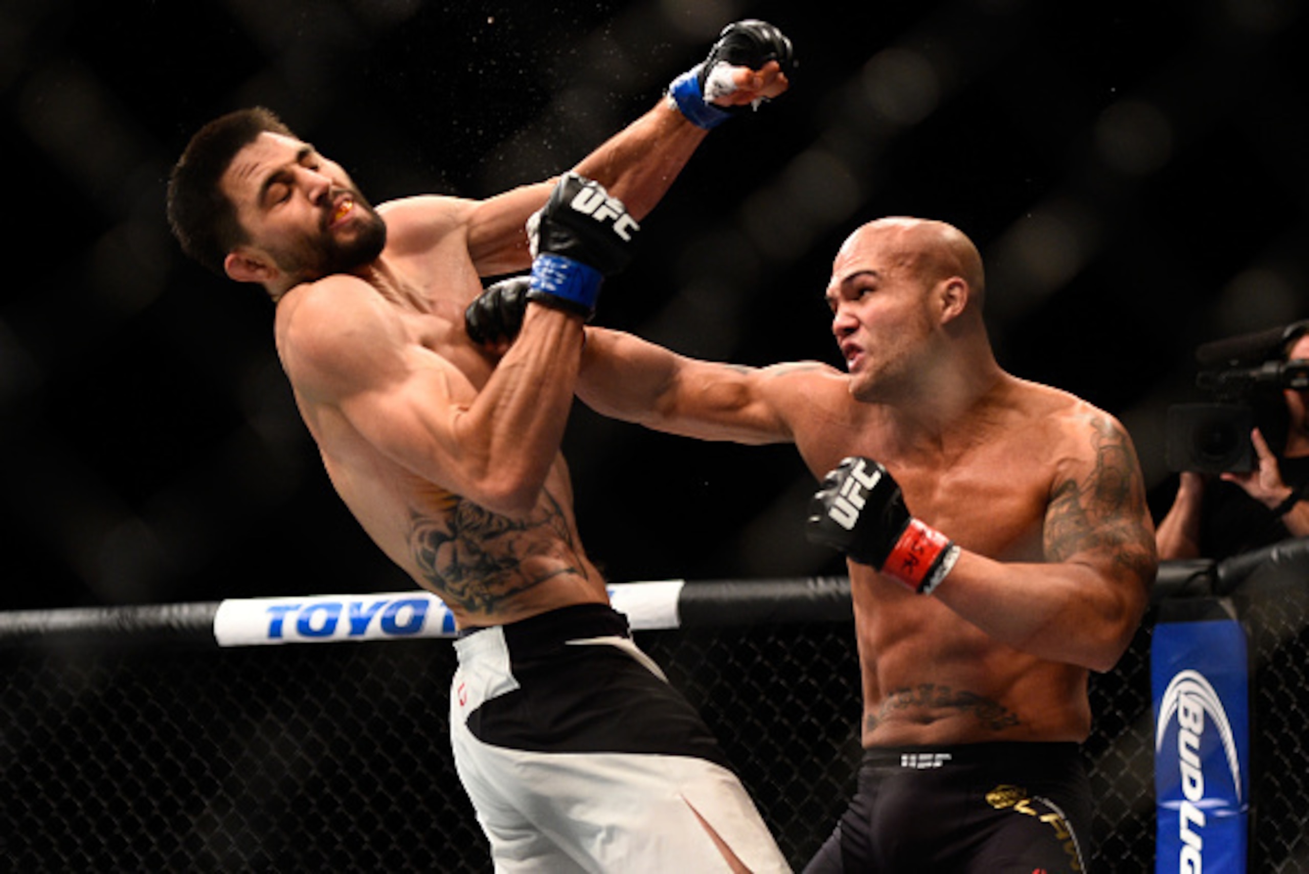 Carlos Condit reels after Robbie Lawler lands a right.