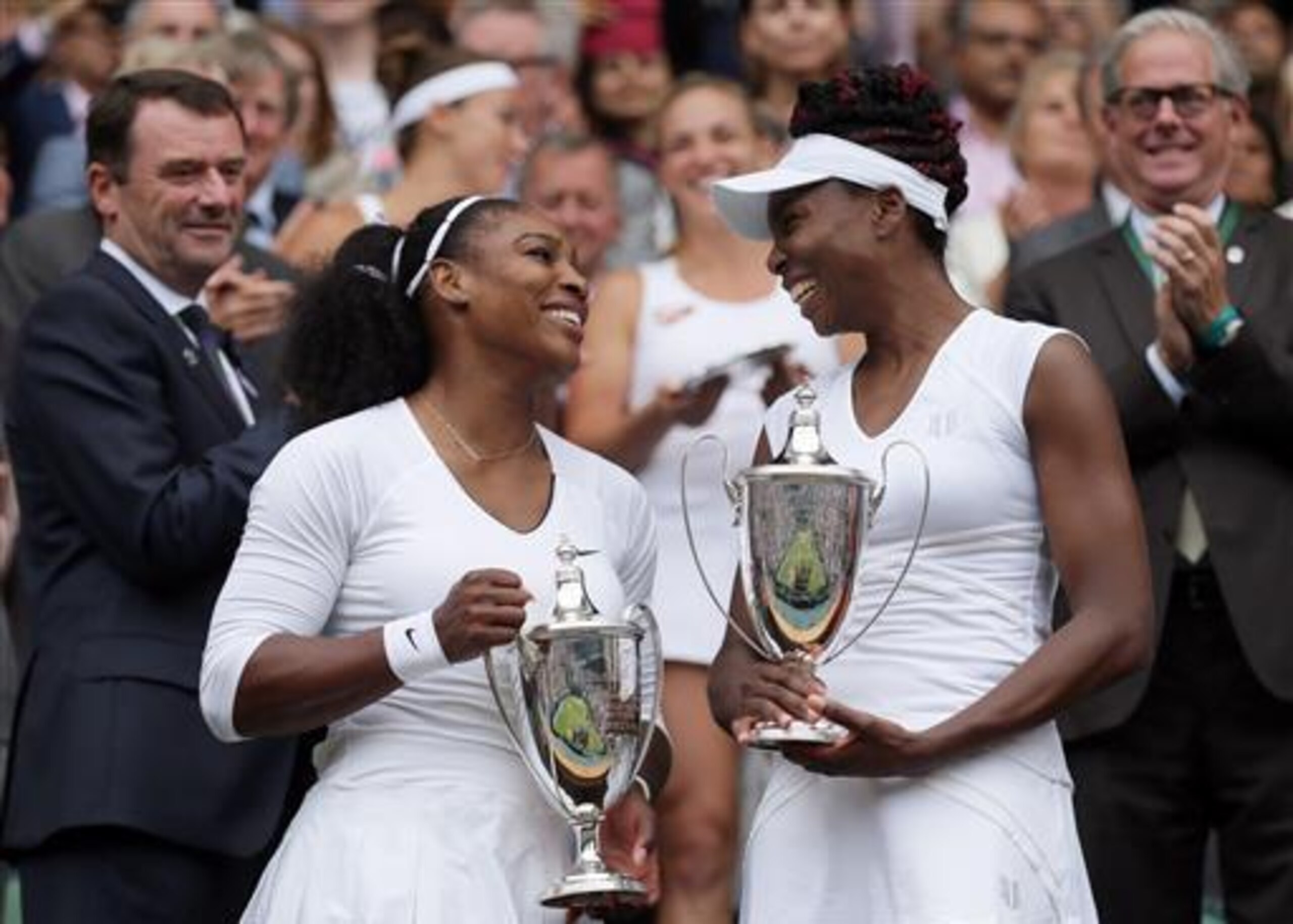 Serena and Venus Williams during the trophy ceremony after winning the doubles title at Wimbledon 2016.