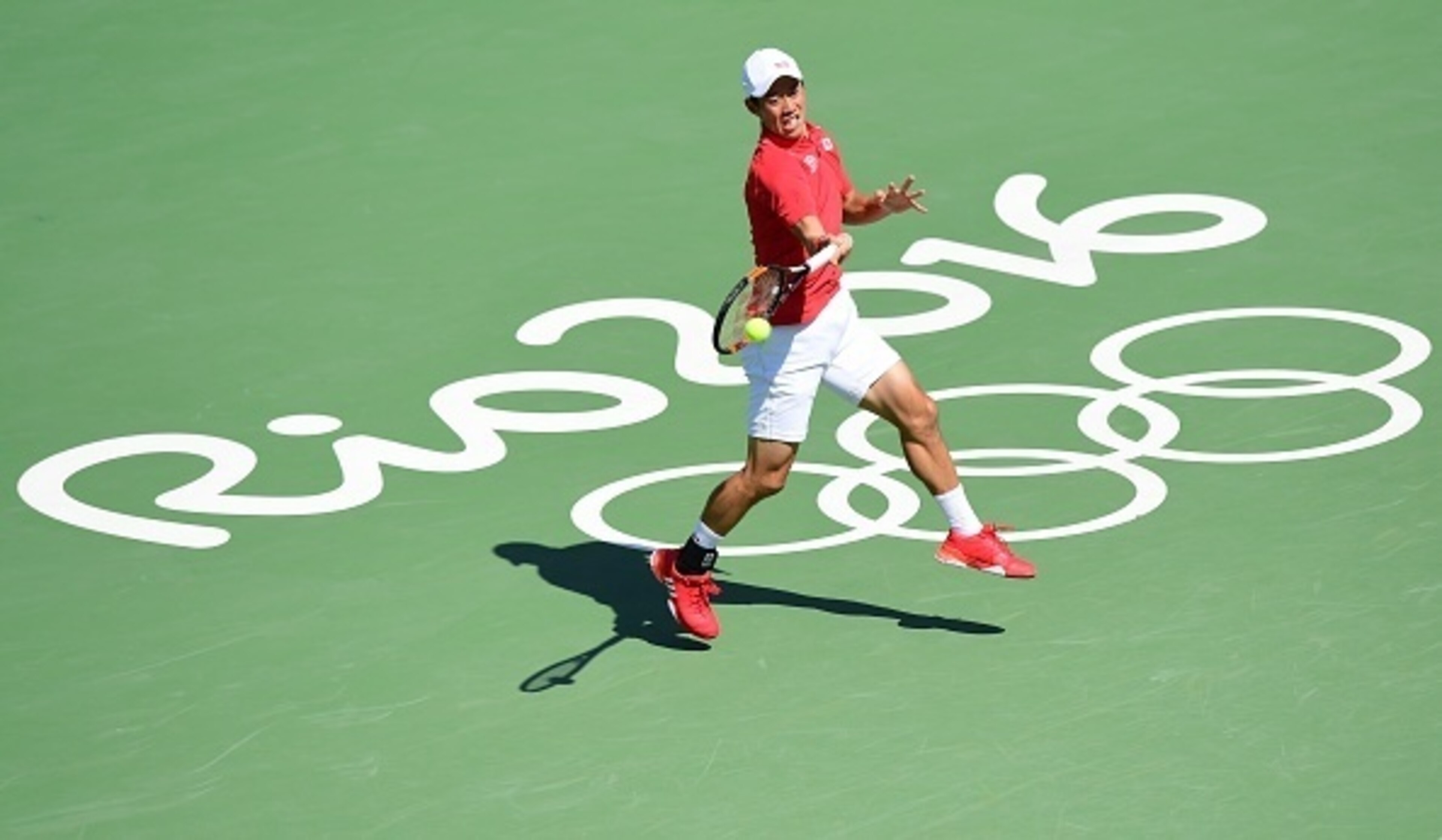 Kei Nishikori hits a forehand during his first-round match at the 2016 Olympics in Rio.