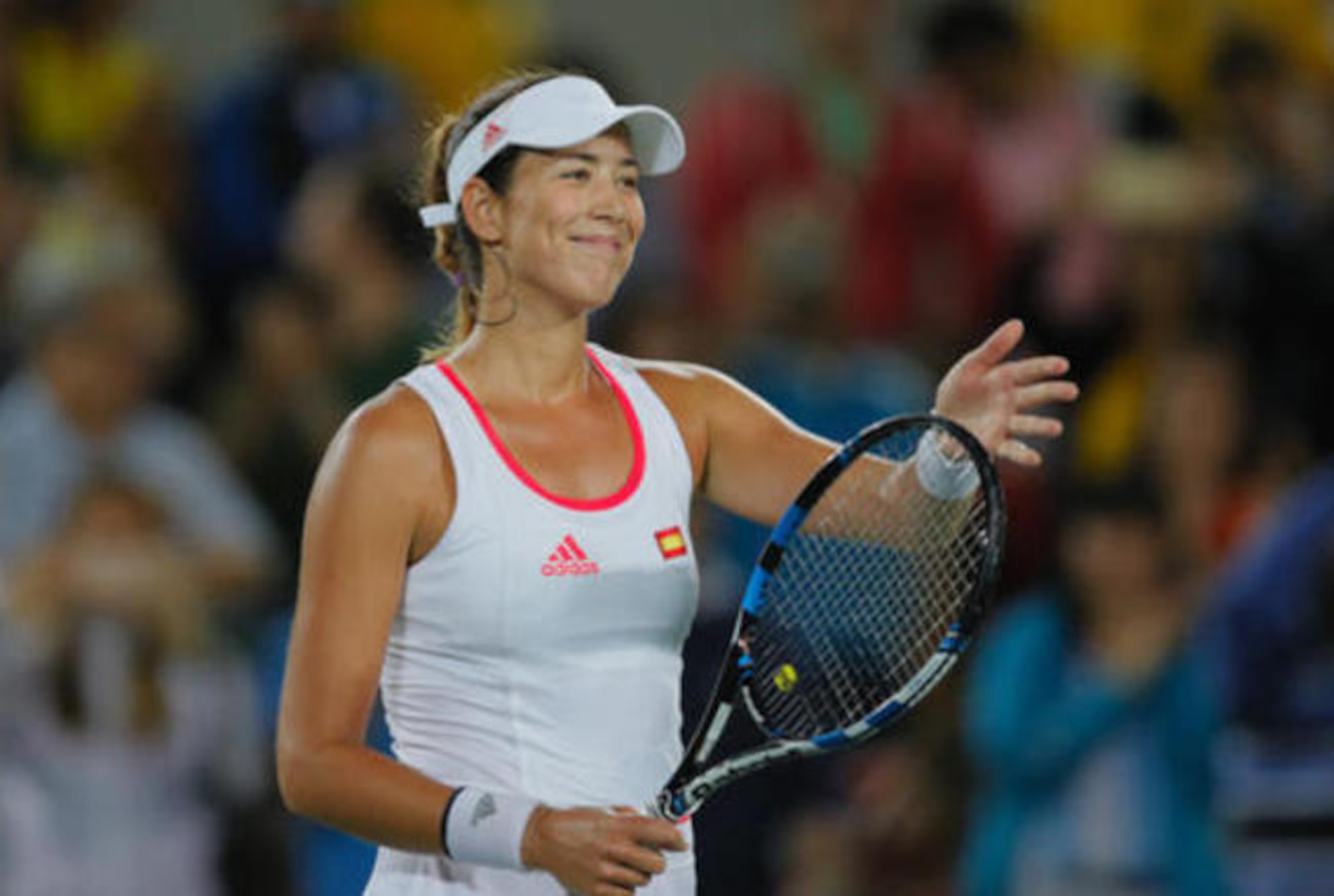 Garbine Muguruza flashes her victorious smile after a first-round win.