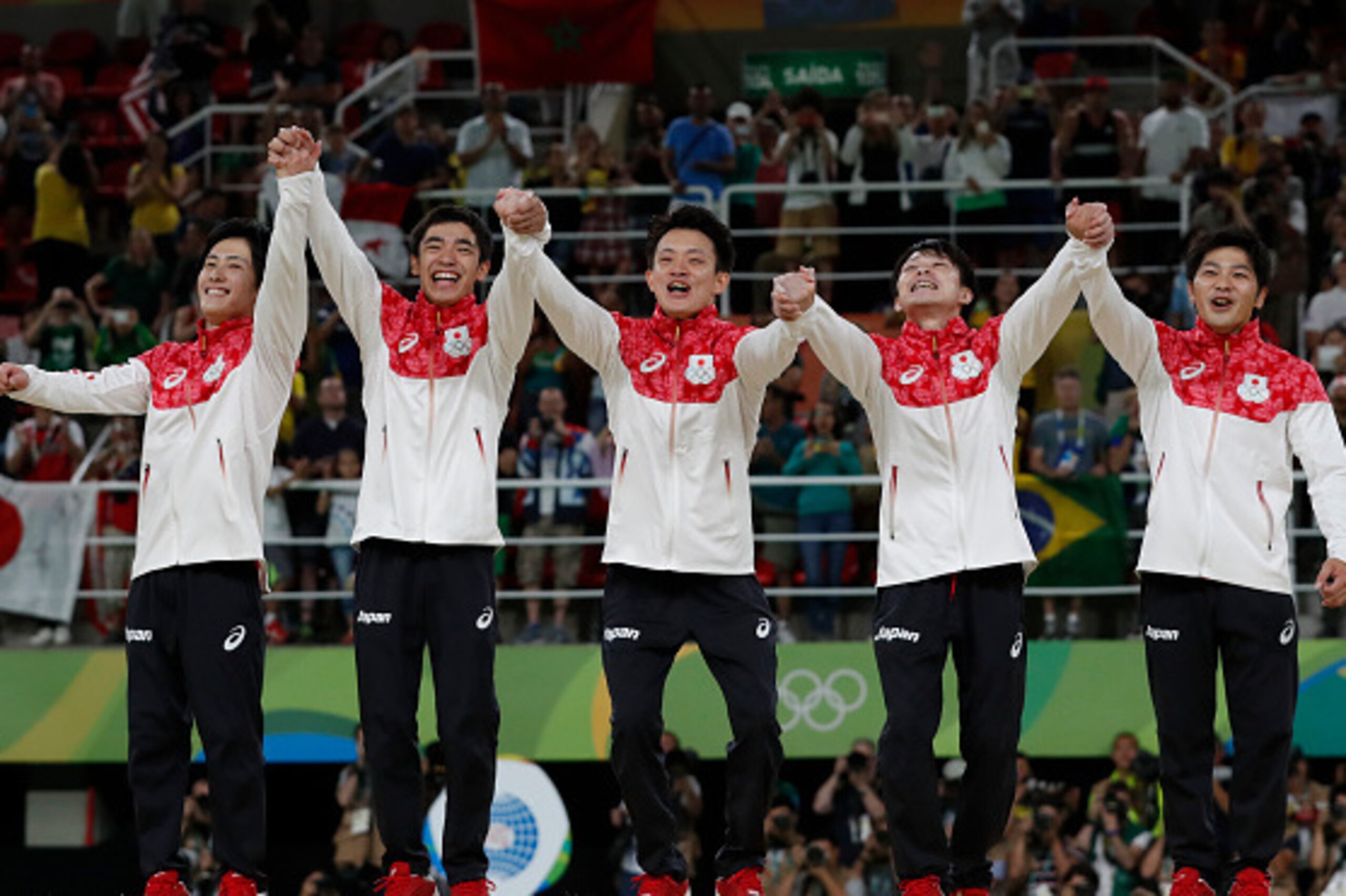 Japan's Men's Gymnastics team celebrates gold.