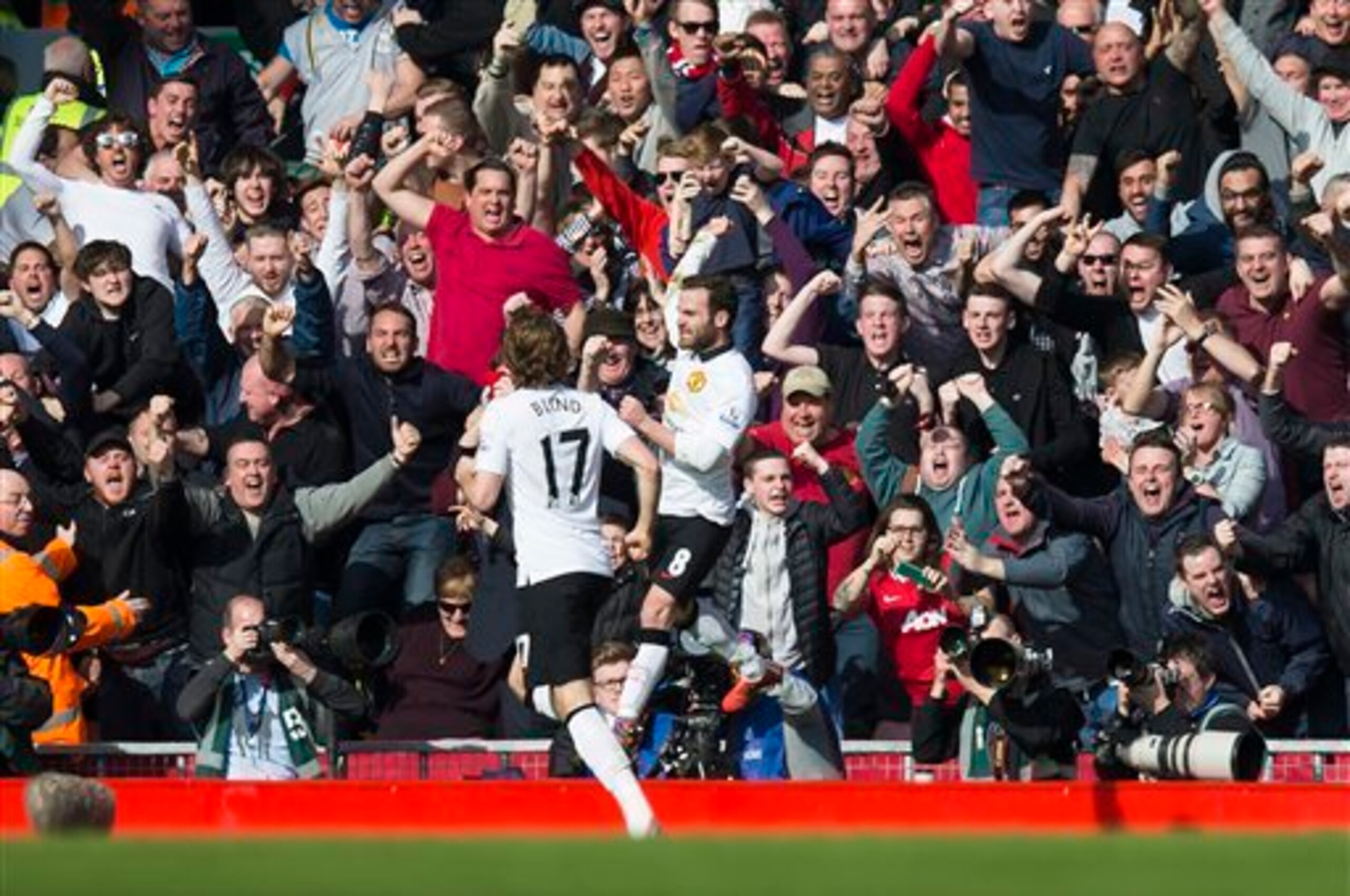 Juan Mata celebrates in front of United's travelling faithful at Anfield.
