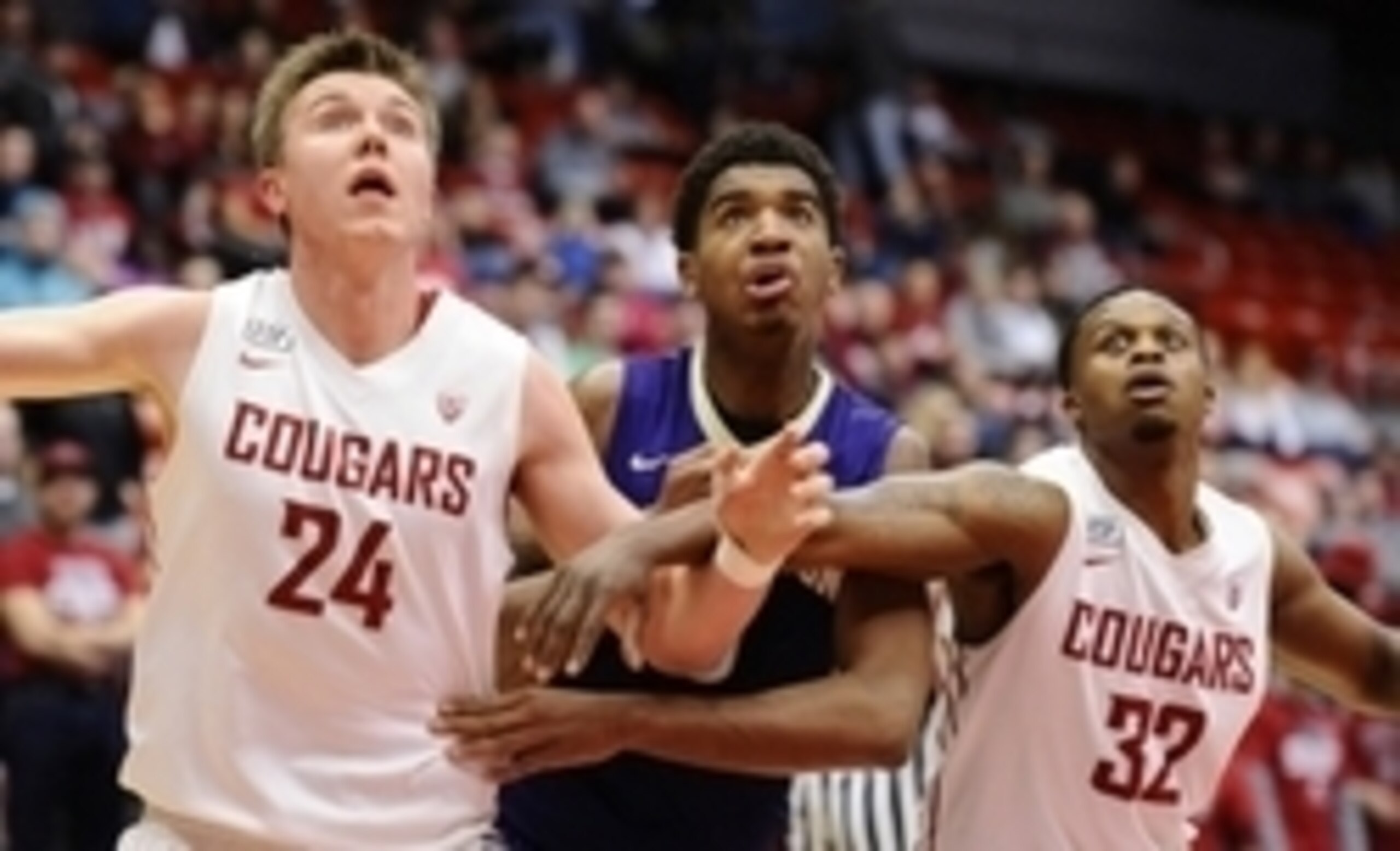 Jan 9, 2016; Pullman, WA, USA; Washington Huskies forward Marquese Chriss (0) fights for position against Washington State Cougars forward Josh Hawkinson (24) and Washington State Cougars guard Que Johnson (32) during the first half at Wallis Beasley Perf