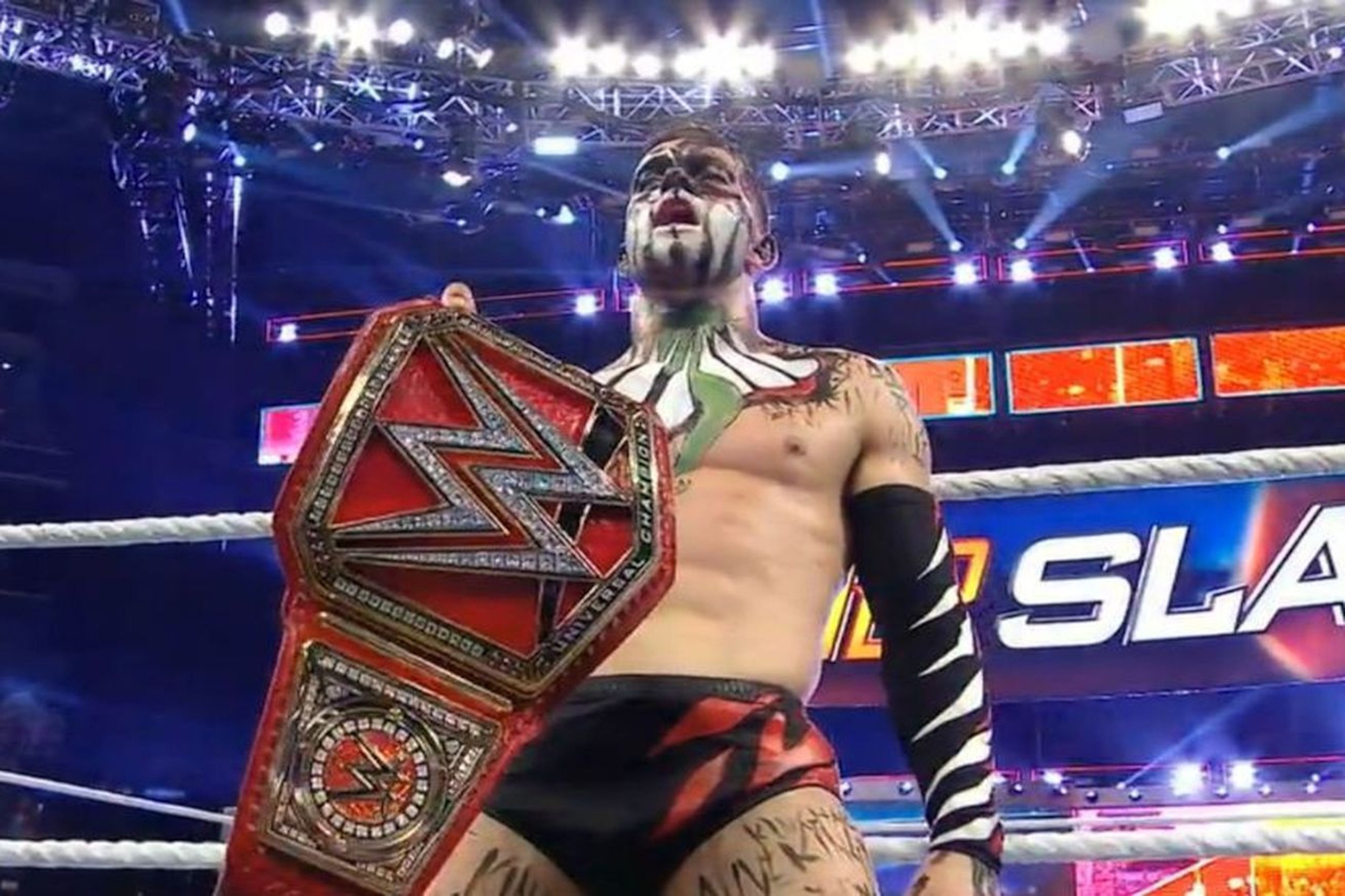 Finn Balor celebrating with his new Universal Championship.