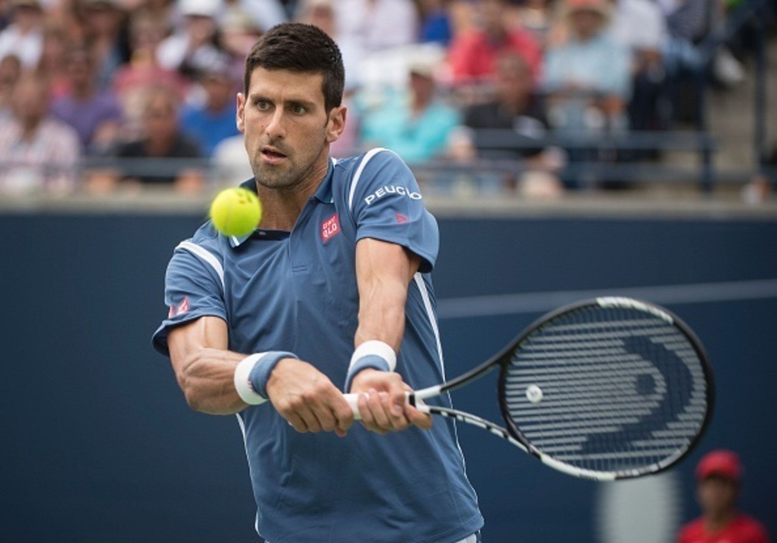 Novak Djokovic hits a backhand at the 2016 Rogers Cup.