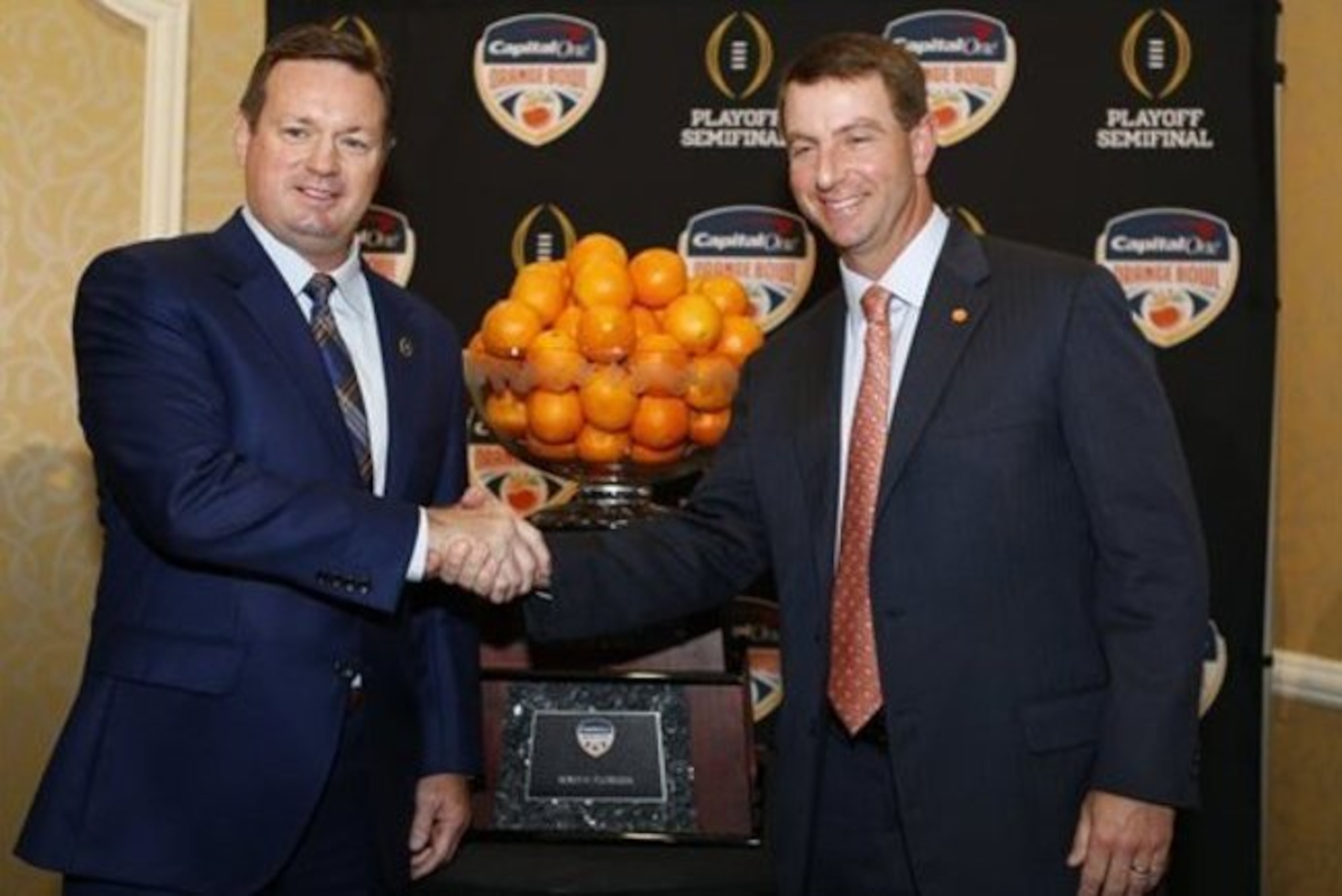 Oklahoma coach Bob Stoops (left) and Clemson coach Dabo Swinney both had reason to smile after a productive recruiting month of August.
