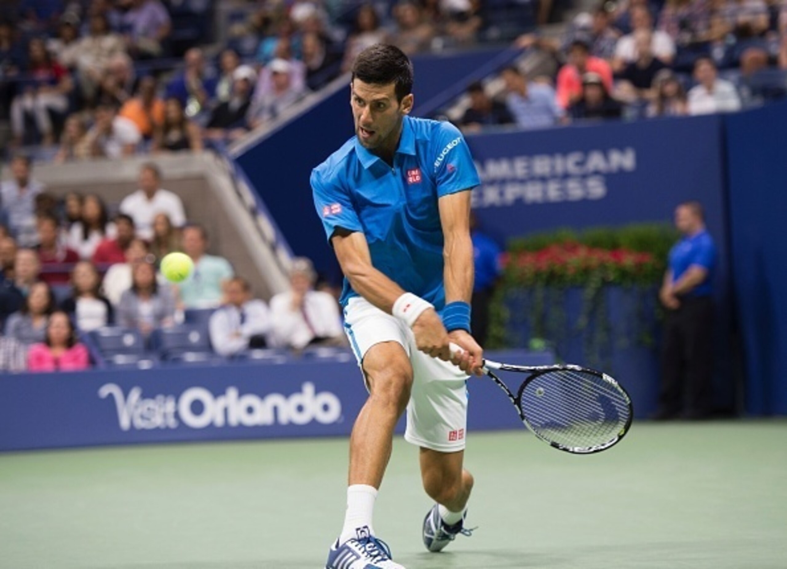 Djokovic slaps a backhand in a fourth-round match against Kyle Edmund.