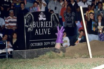 The Undertaker reaching out from the grave.