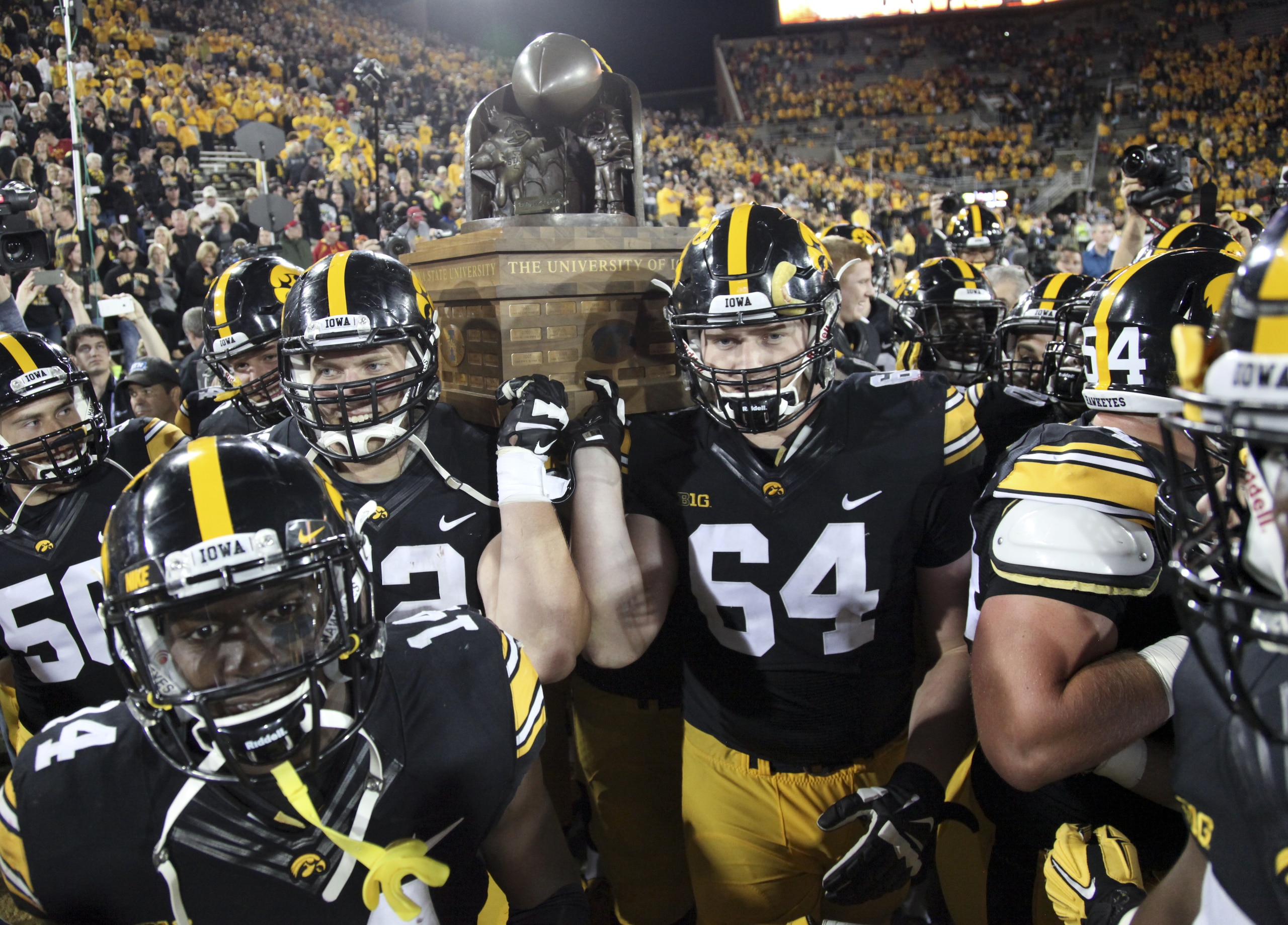 Iowa celebrates after retaining the Cy-Hawk Trophy awarded to the winner of the annual Iowa-Iowa State game.