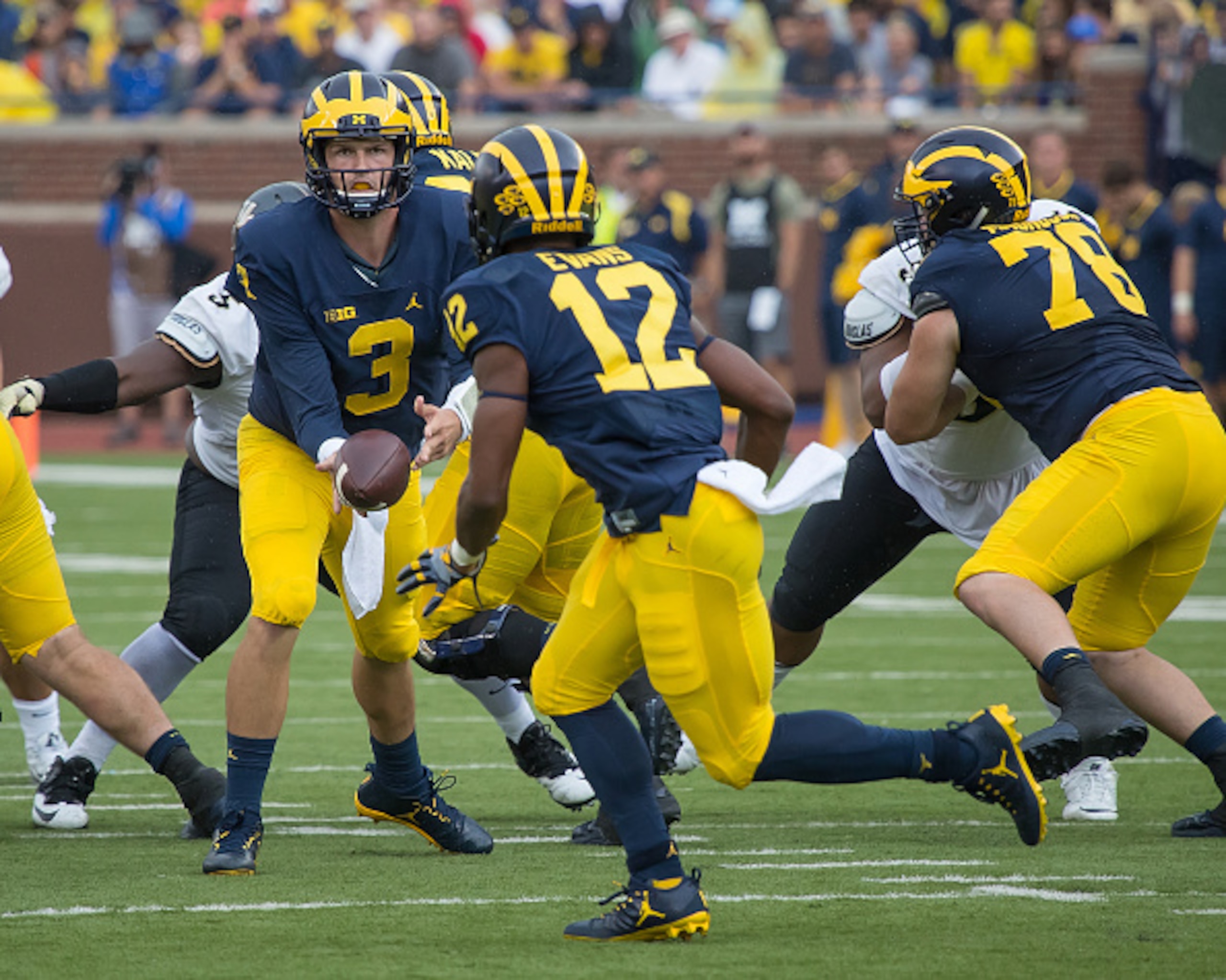 Chris Evans (12) takes a pitch from Wilton Speight.