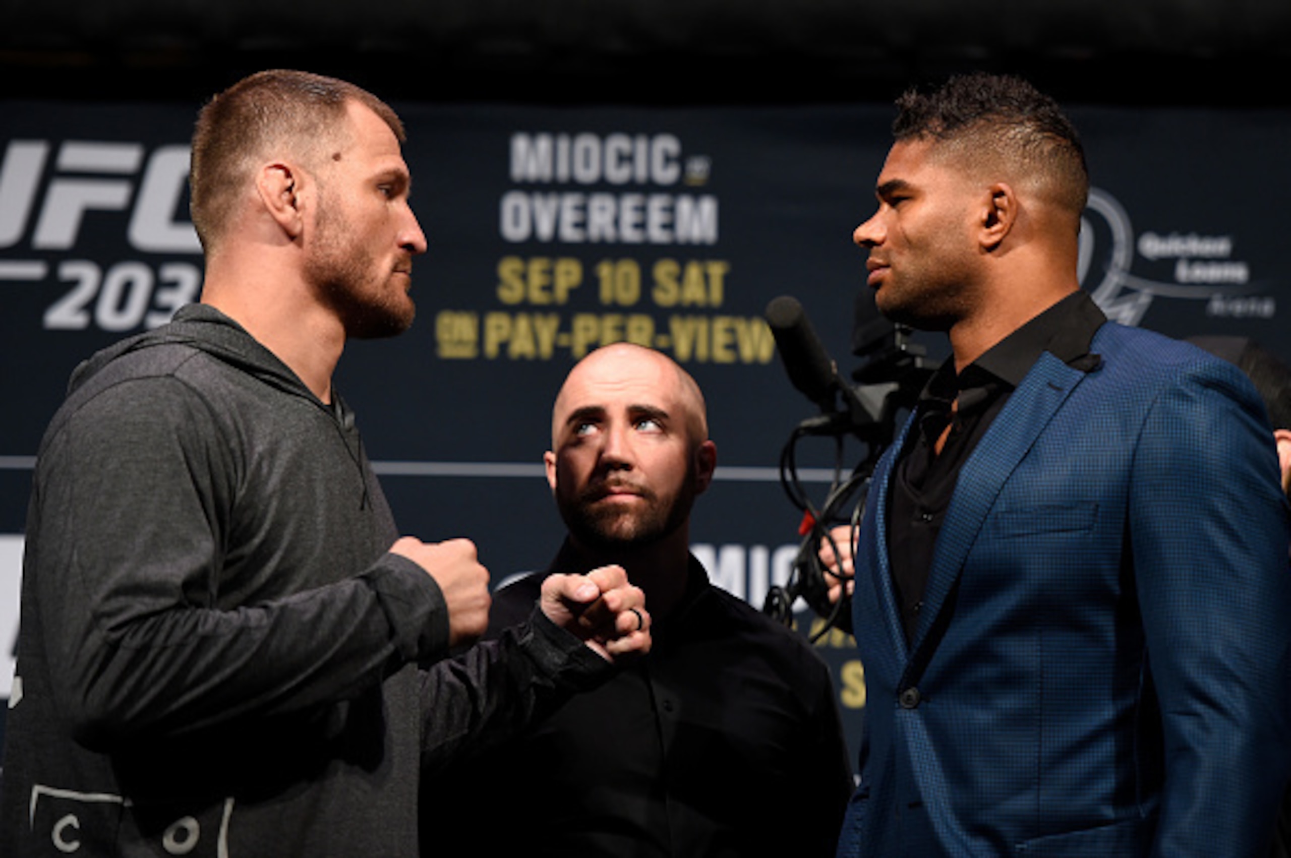 Stipe Miocic, left, faces off with Alistair Overeem, right.