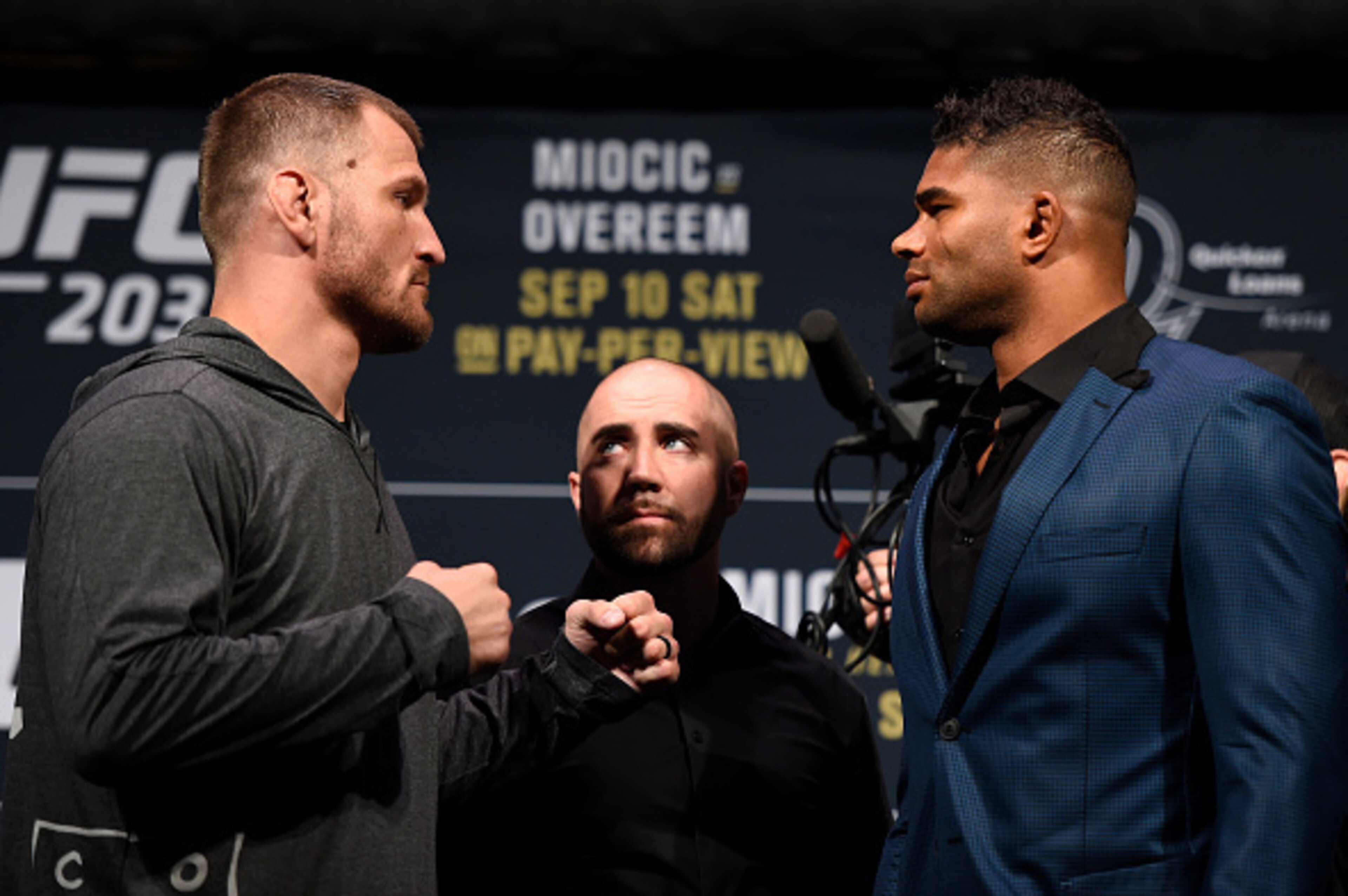 Stipe Miocic, left, faces off with Alistair Overeem, right.