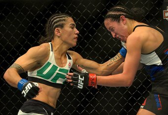 Jessica Andrade, left, punches Jessica Penne.