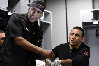 Werdum, right, gets his hands wrapped.