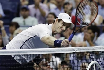 Andy Murray smashes his racket into the net after losing a game in the U.S. Open quarterfinals.