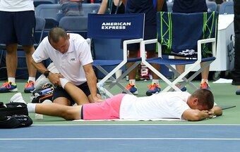 Mikhail Youzhny receives medical attention during a match at the 2016 U.S. Open.