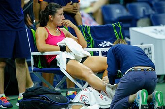 Anastasija Sevastova sits during the changeover as her ankle is wrapped following an injury she suffered during her 2016 U.S. Open quarterfinal match.