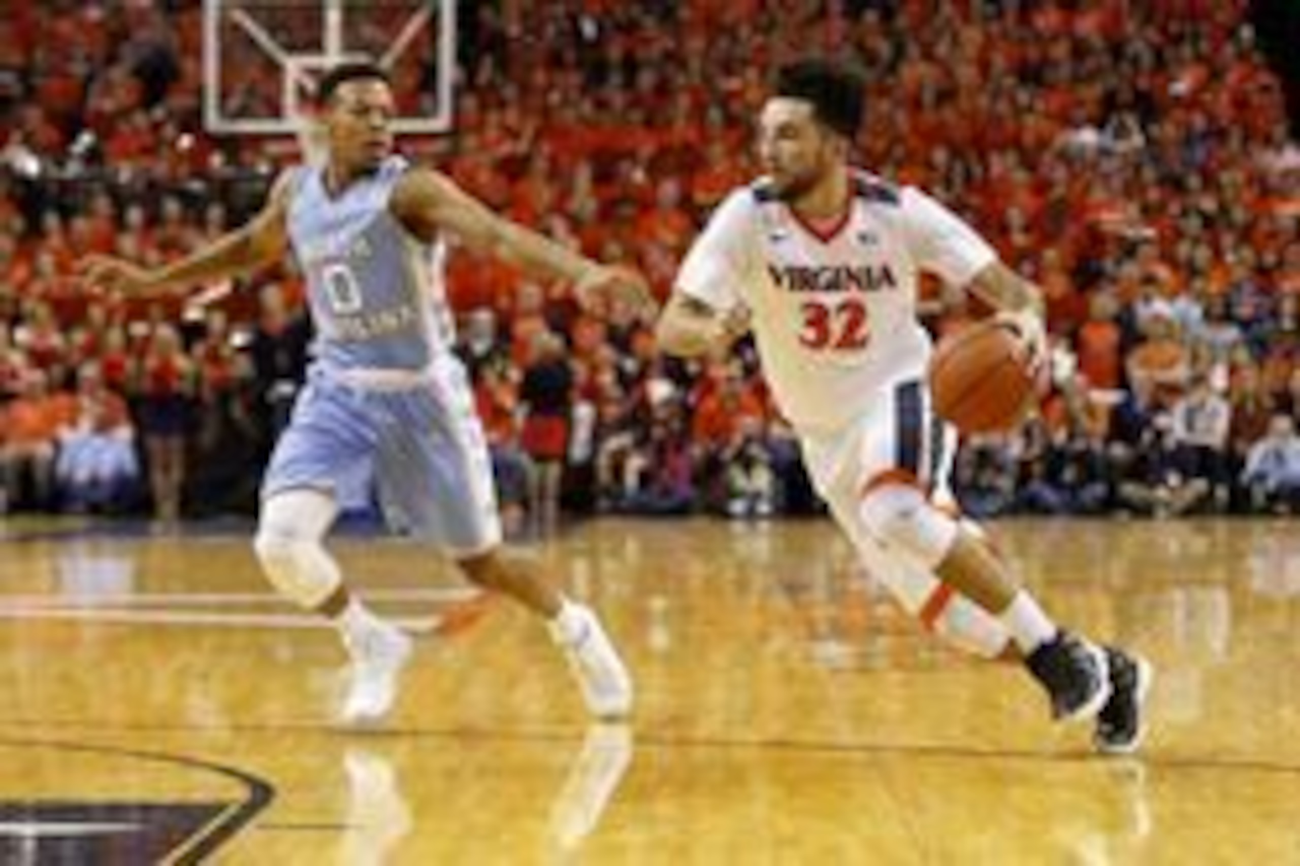 North Carolina's Nate Britt (0) and Virginia's London Perrantes (32)