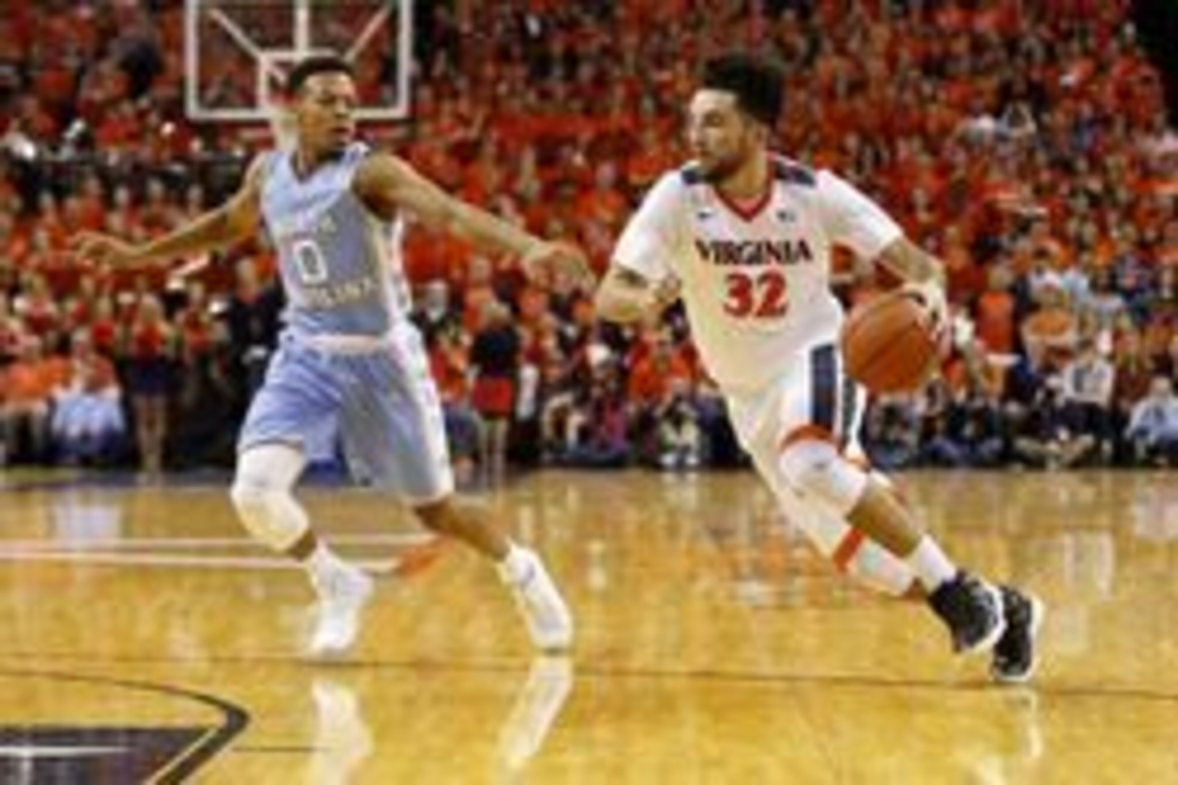 North Carolina's Nate Britt (0) and Virginia's London Perrantes (32)