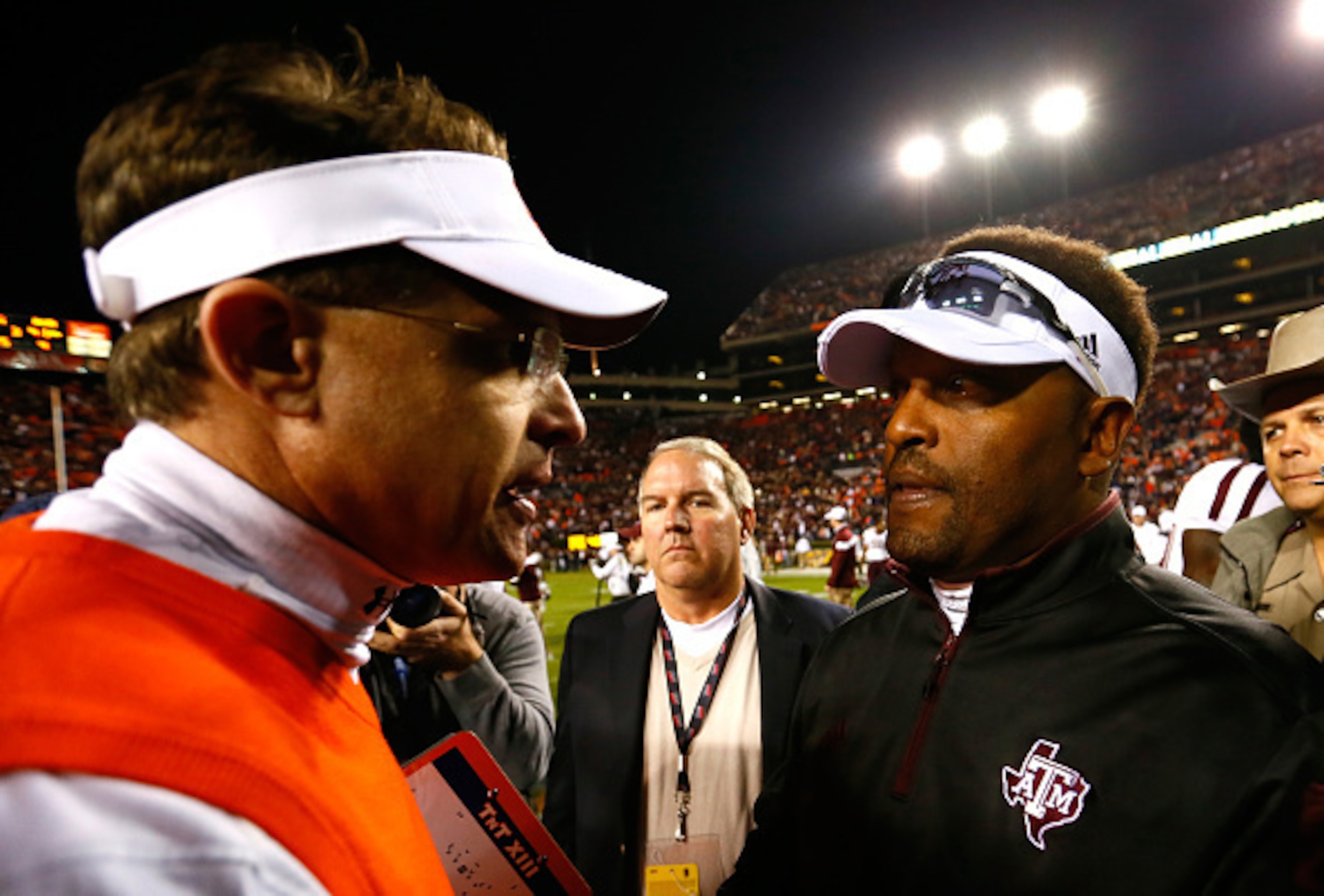 Auburn head coach Gus Malzahn (left) and Texas A&M head coach Kevin Sumlin