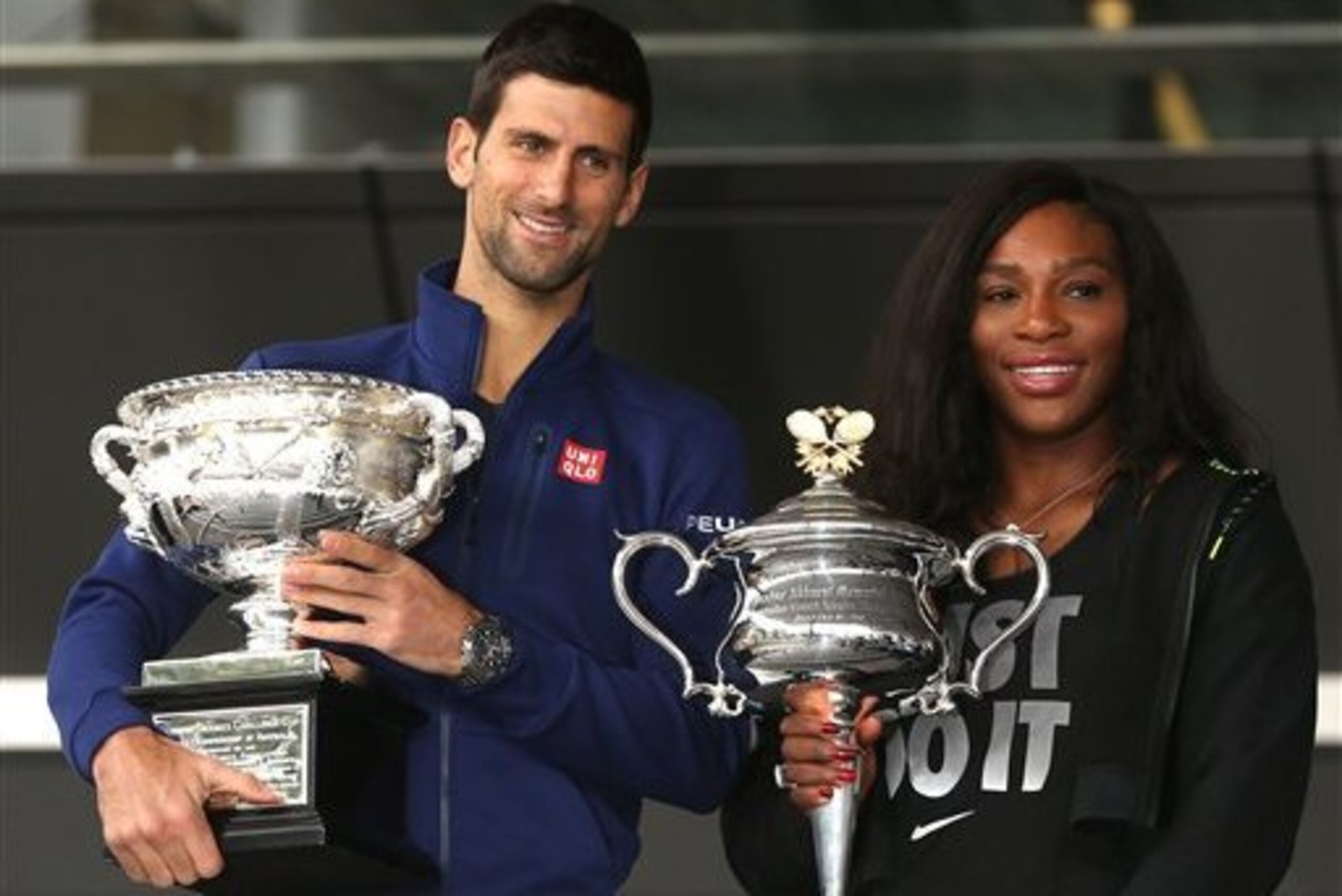 Novak Djokovic and Serena Williams hold trophies they won in 2015 ahead of the 2016 Australian Open draw ceremony.