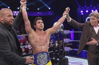 T.J. Perkins posing with William Regal, Triple H and his new Cruiserweight Championship.