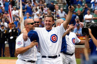 Chicago Cubs' Anthony Rizzo, right, and David Ross celebrate their division title before a baseball game against the Milwaukee Brewers Friday, Sept. 16, 2016, in Chicago. (AP Photo/Nam Y. Huh)