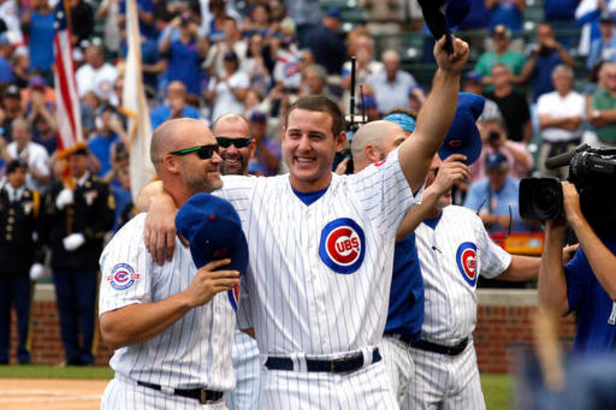 Chicago Cubs' Anthony Rizzo, right, and David Ross celebrate their division title before a baseball game against the Milwaukee Brewers Friday, Sept. 16, 2016, in Chicago. (AP Photo/Nam Y. Huh)