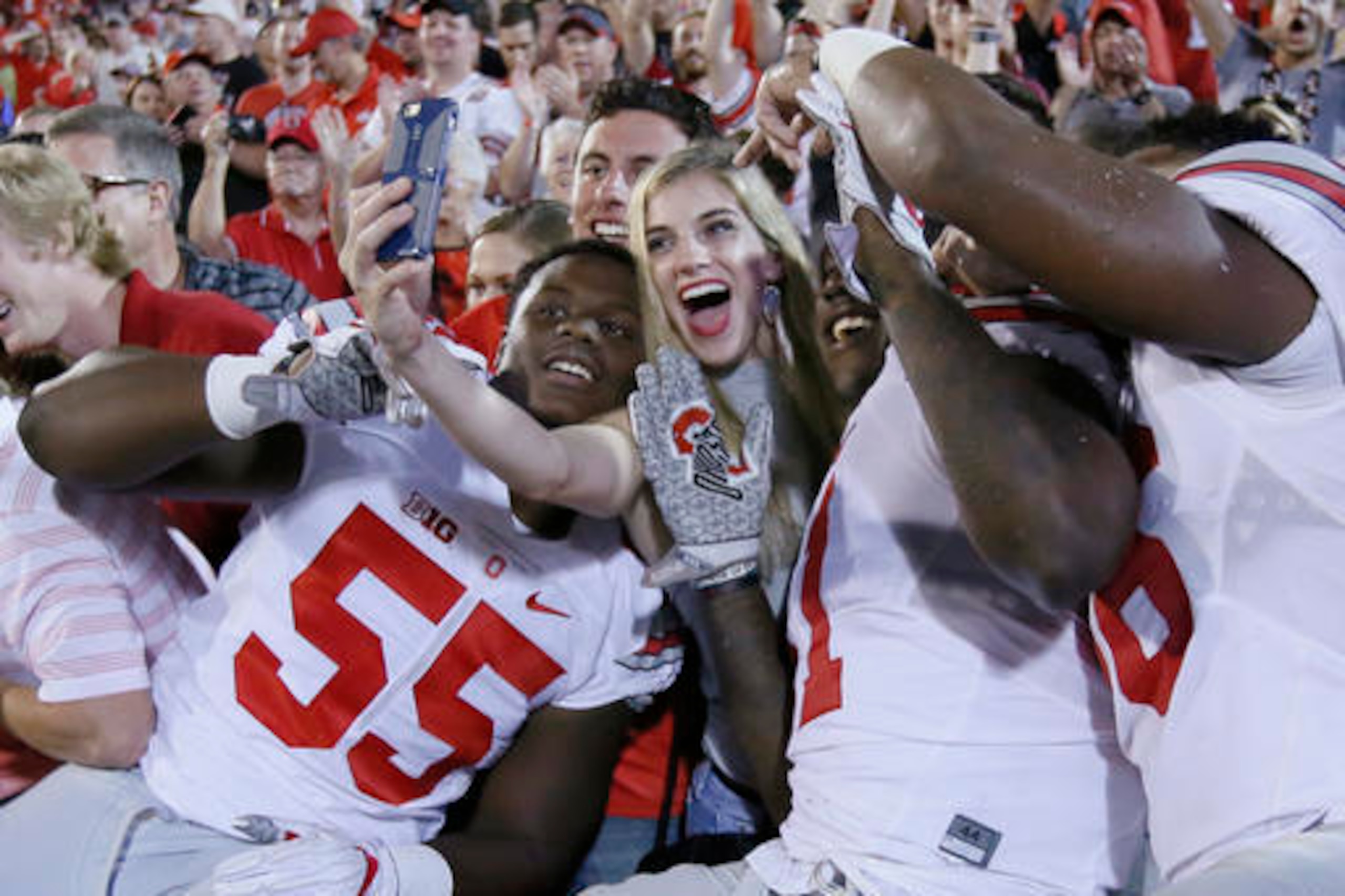 Buckeye players celebrate with fans after beating Oklahoma