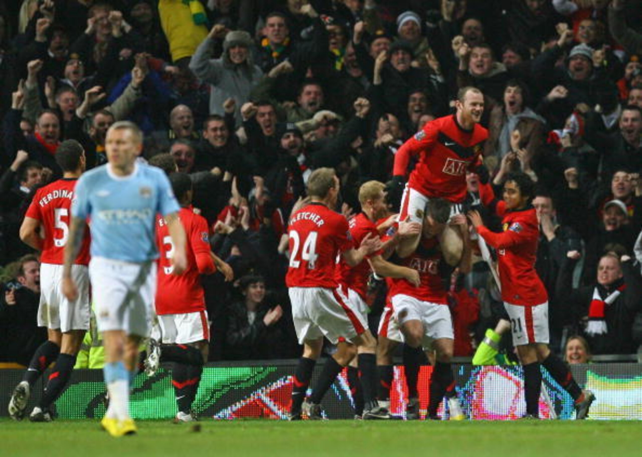 Rooney is held aloft after his injury-time winner.